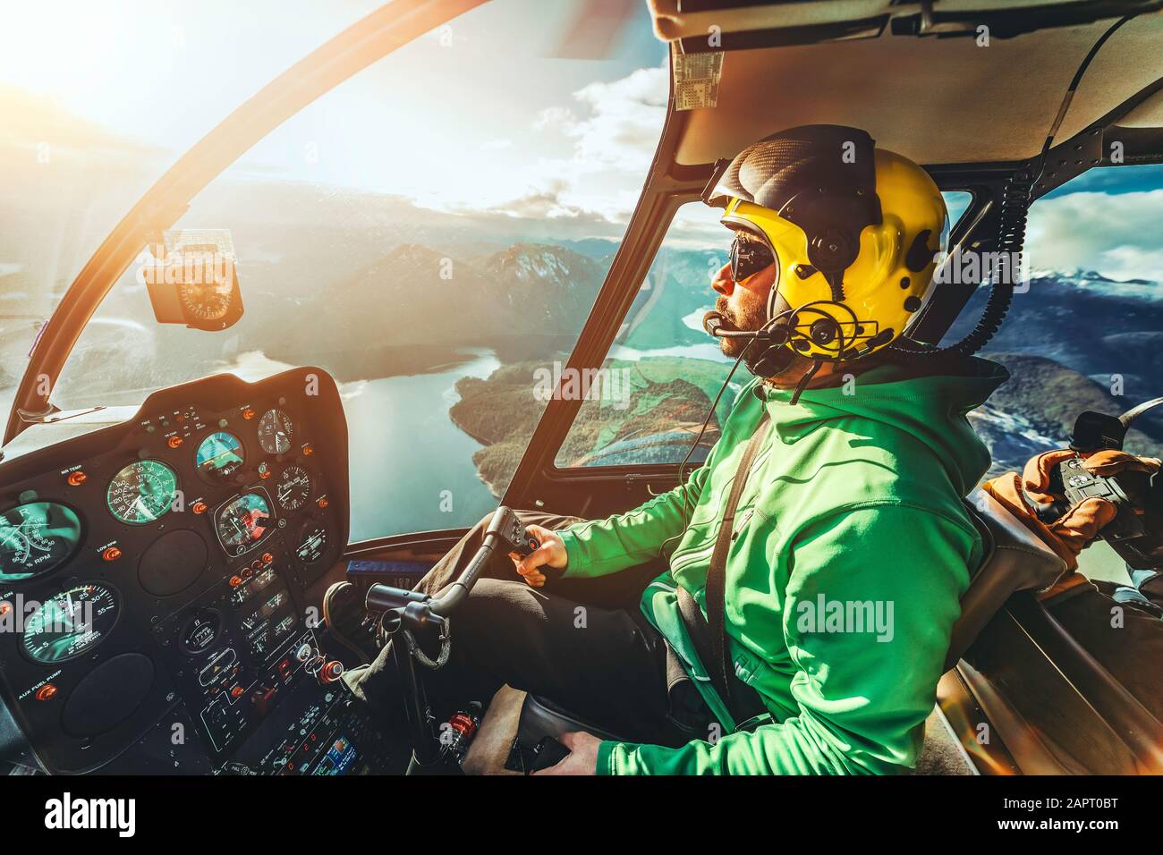 Helicopter pilot. Helicopter flying aircraft over mountains and ocean ...