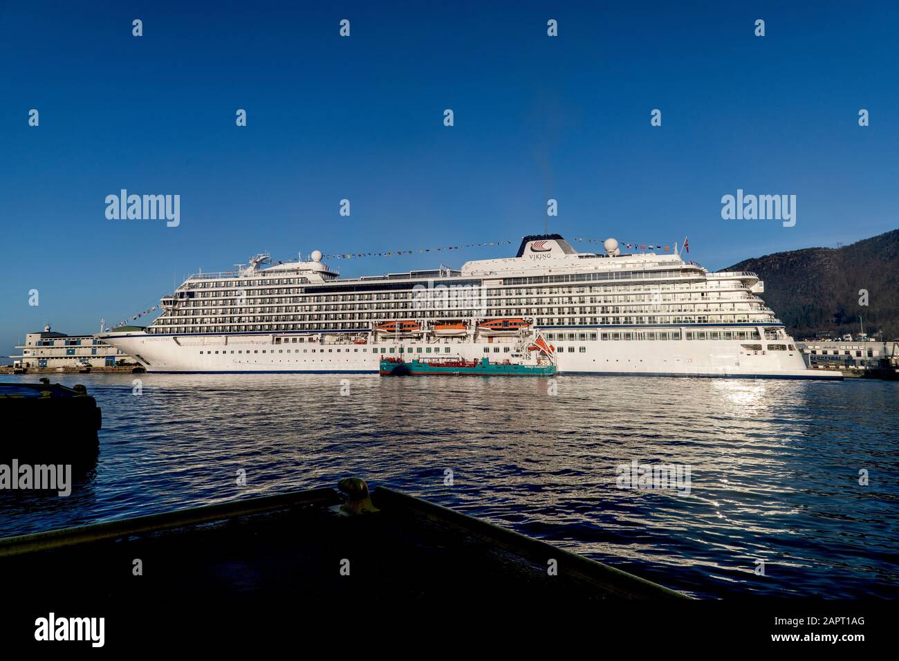 Cruise ship Viking Star at Skolten quay in port of Bergen, Norway. Tanker vessel Oslo Tank alongside the large cruise ship. Stock Photo