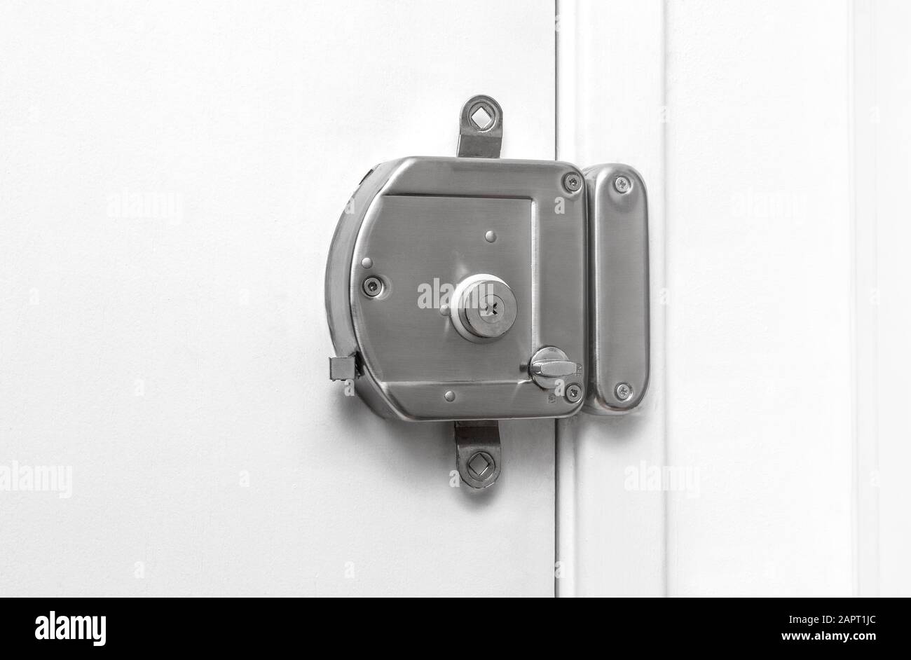 overhead door lock on white door Stock Photo