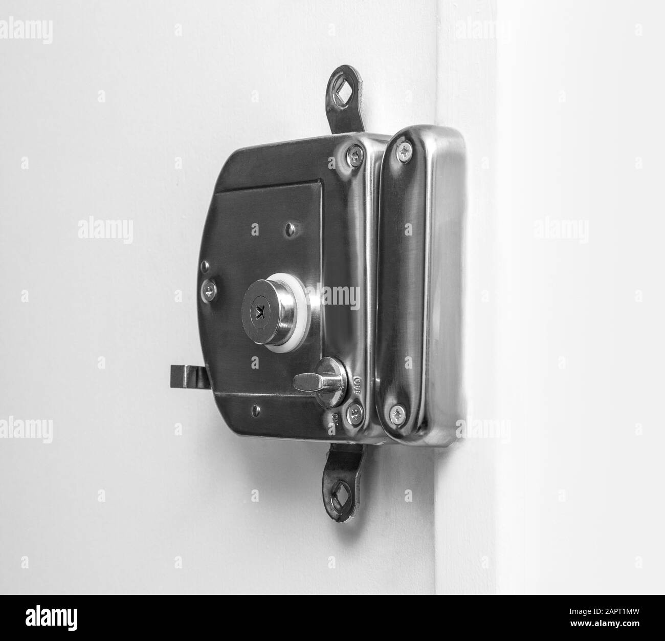 overhead door lock on white door Stock Photo