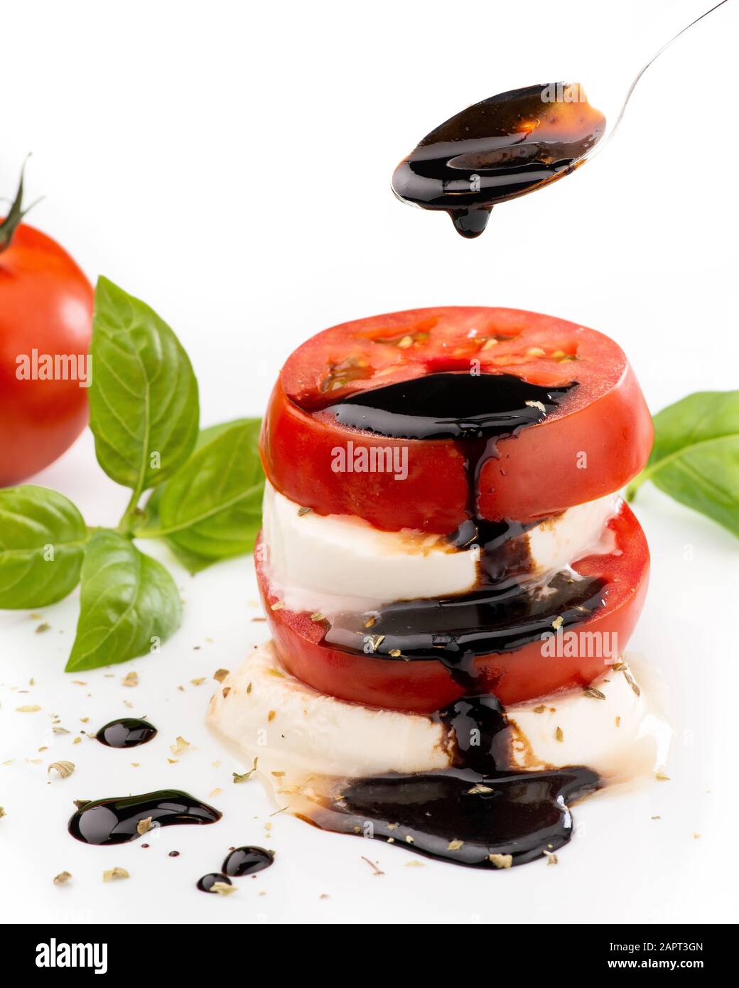 Caprese salad with mozzarella cheese and tomato topped with a glaze of