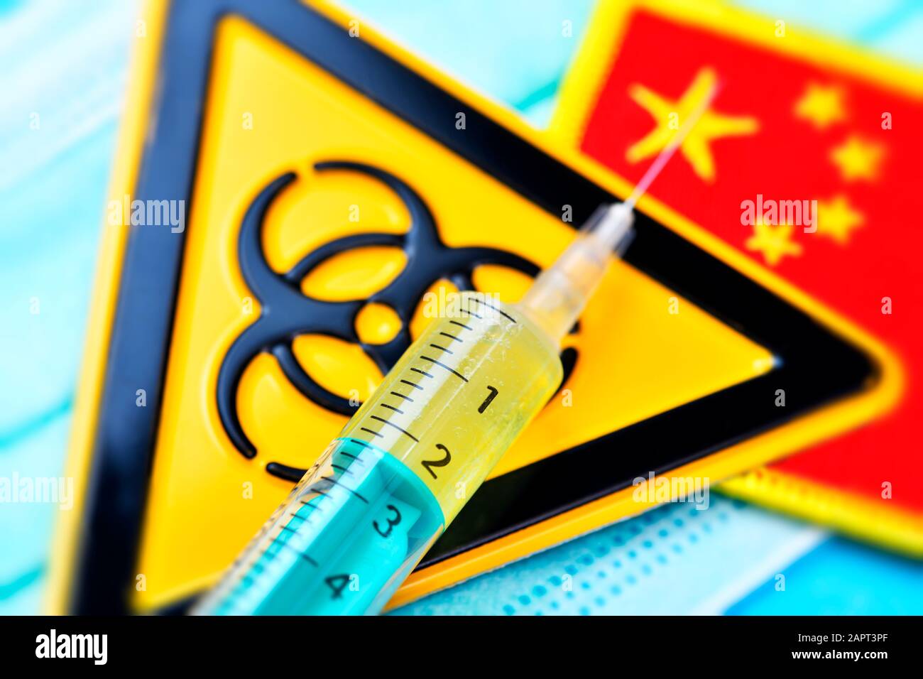 Biohazard sign and syringe on face mask and flag of China, coronavirus outbreak Stock Photo