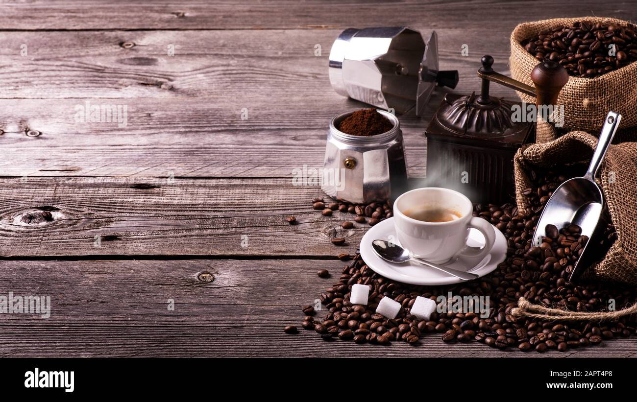 on the rustic wooden table a cup of hot coffee, a vintage coffee ...