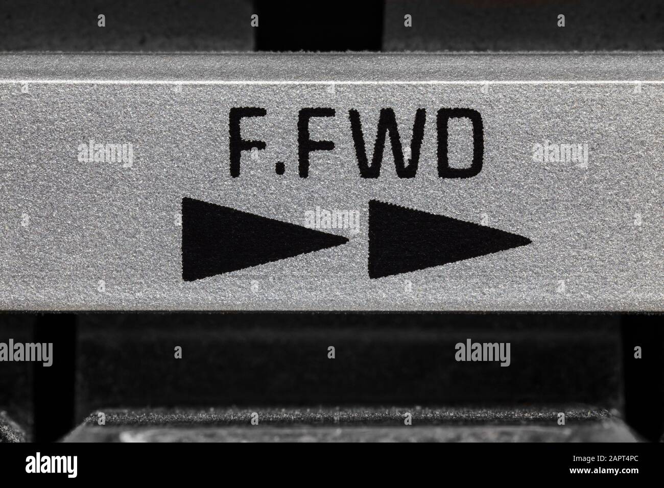 Macro close up photograph of vintage boombox tape machine fast forward button detail. Stock Photo