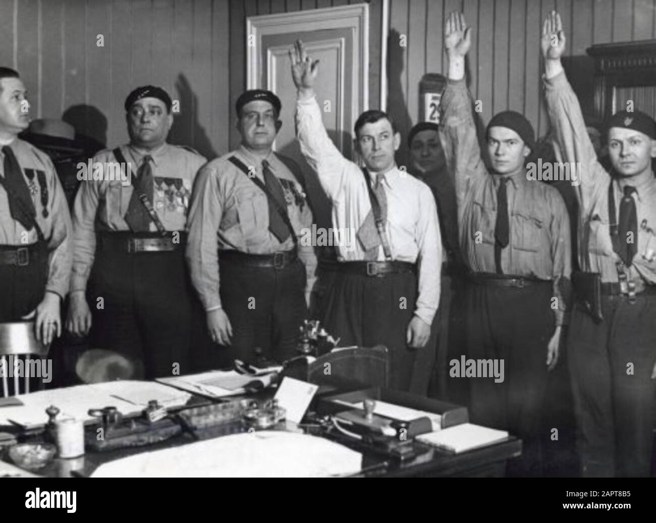 The framework of the French fascists (the francists): Vlnr Marcel Bucard, Paul Lafitte and J.-B. Lherault. Some recruits bring the Hitler salute and carry weapons, the shirts are blue. France, 30 January 1934.; Stock Photo