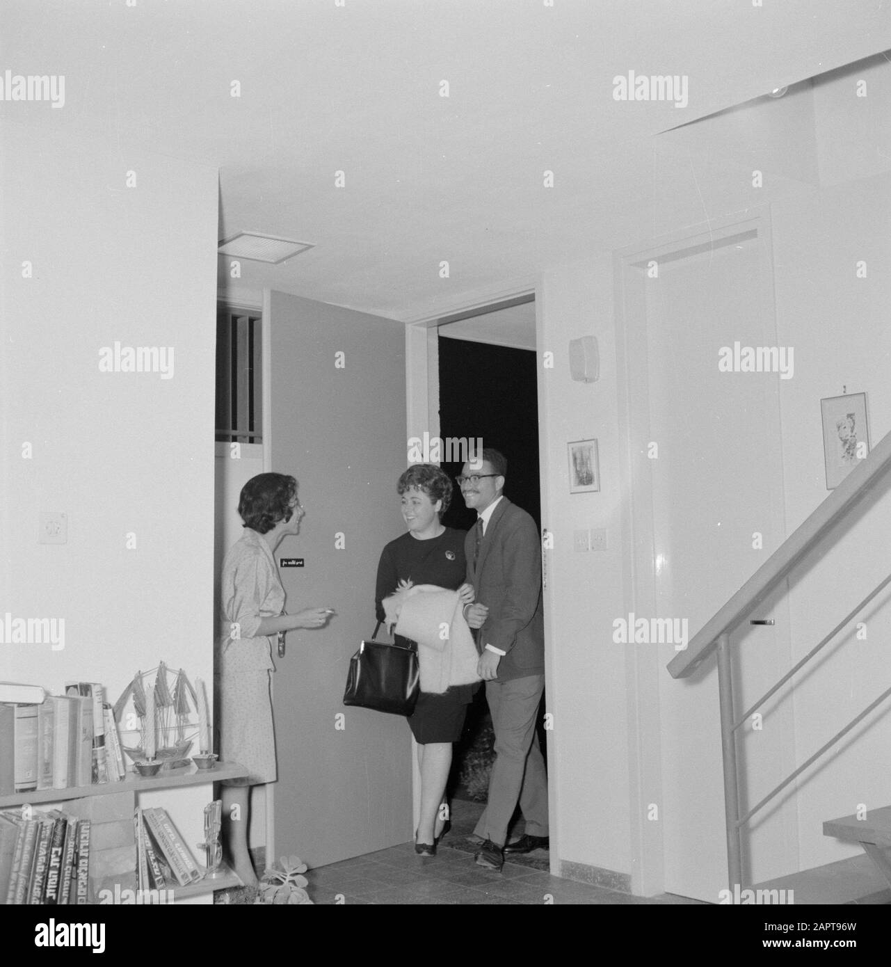 Welcoming guests into home Black and White Stock Photos & Images - Alamy