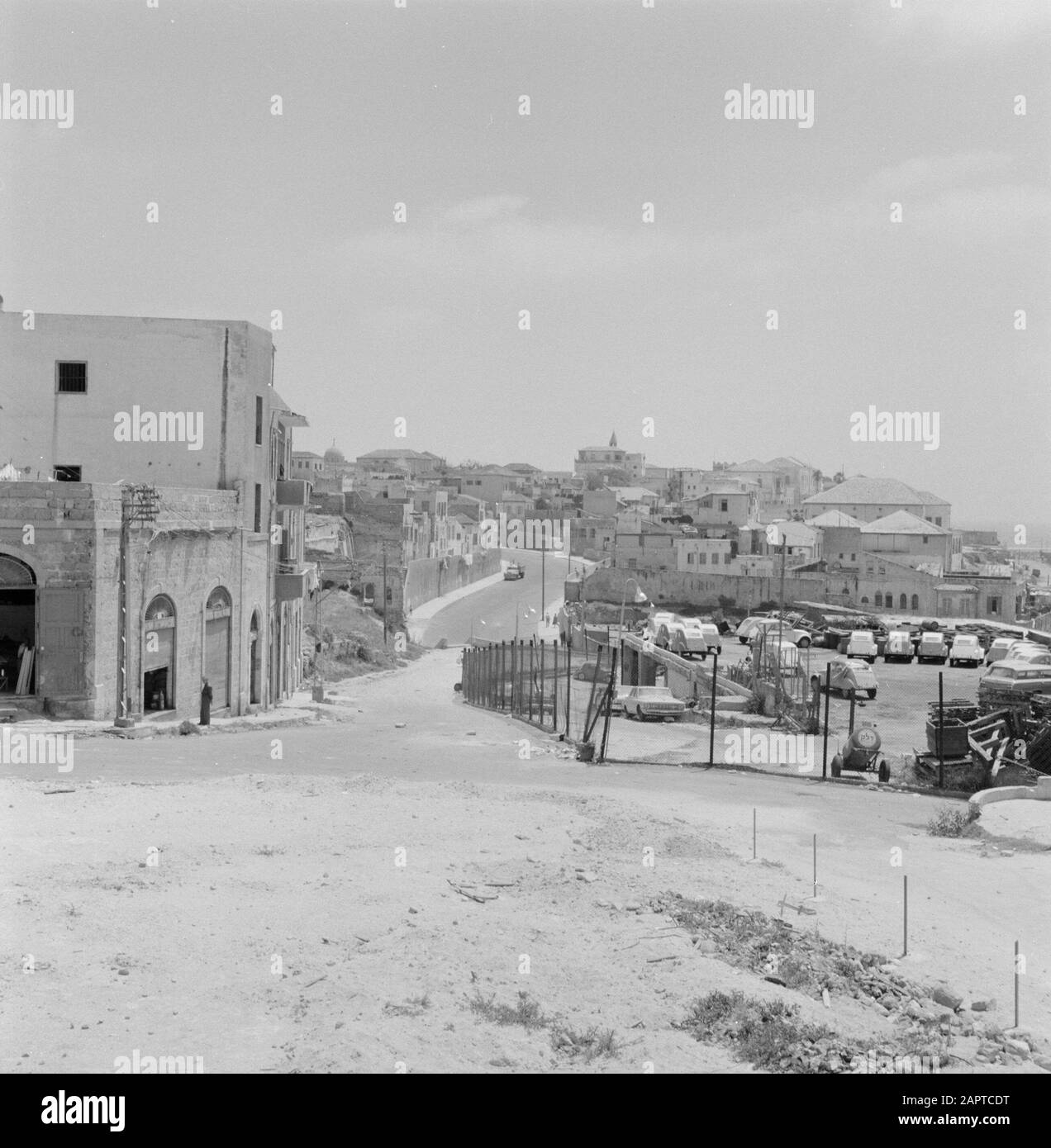 Israel: Jaffa (Tel Aviv)  View of the village with front right a parking space for deux-chevaux (Citroën 2CV, 'ugly duck') Annotation: Jaffa is now a city district of Tel Aviv Date: 1964-1965 d Location: Israel, Jaffa, Tel Aviv Keywords: cars, villages, panoramas, parking lots Stock Photo