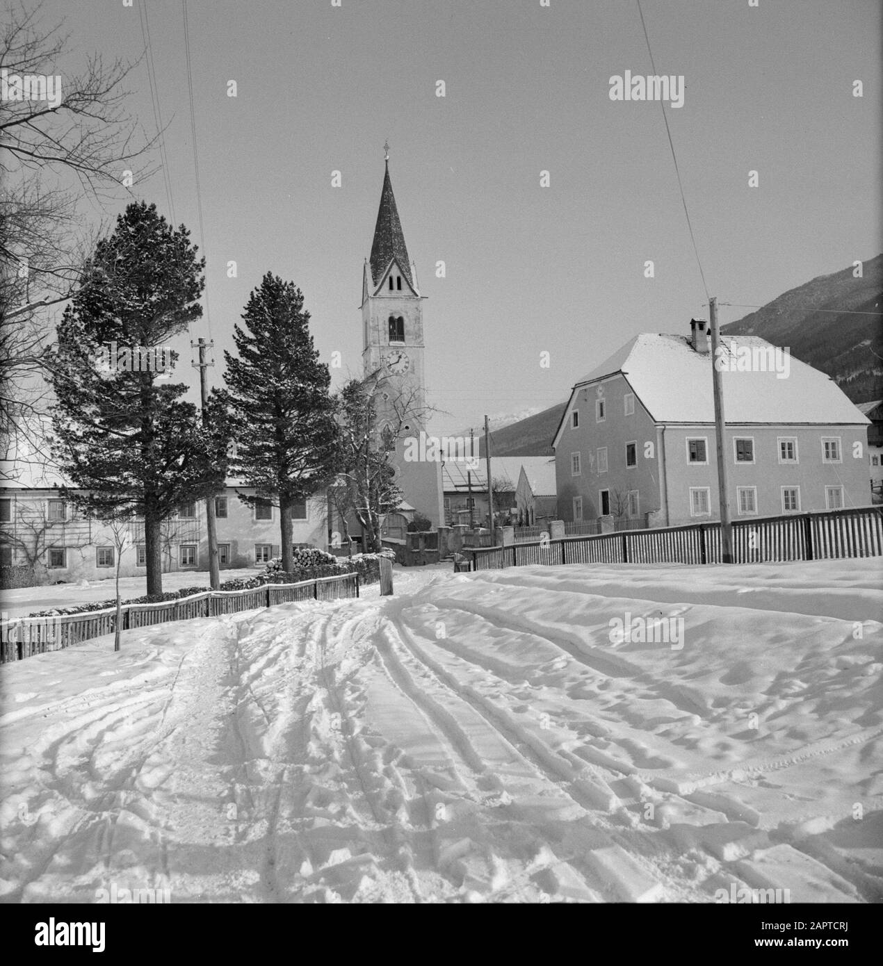 Winter in Tirol  View of Sistrans in the snow Date: January 1960 Location: Austria, Sistrans, Tyrol Keywords: mountains, villages, church buildings, snow, winter, homes Stock Photo