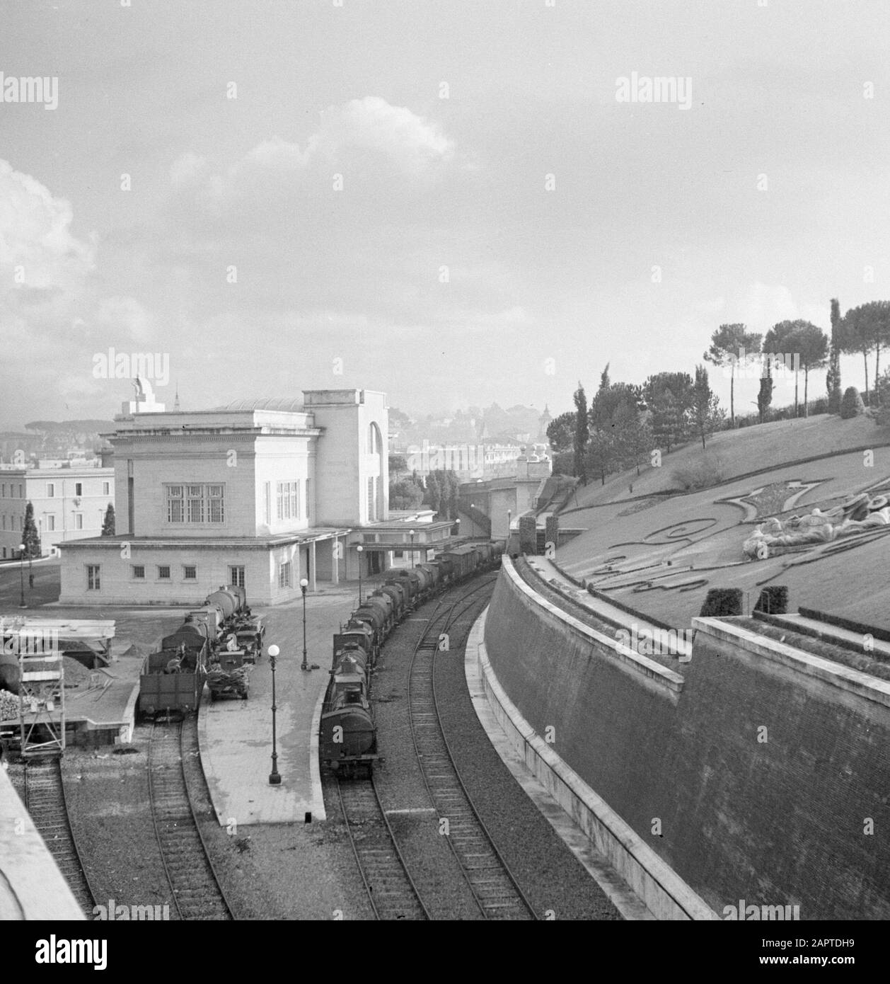 Rome: Visit to Vatican City Freight train at Vatican City Station Date: December 1937 Location: Italy, Rome, Vatican City Keywords: buildings, freight trains, platforms, railways, stations, steam locomotives Stock Photo