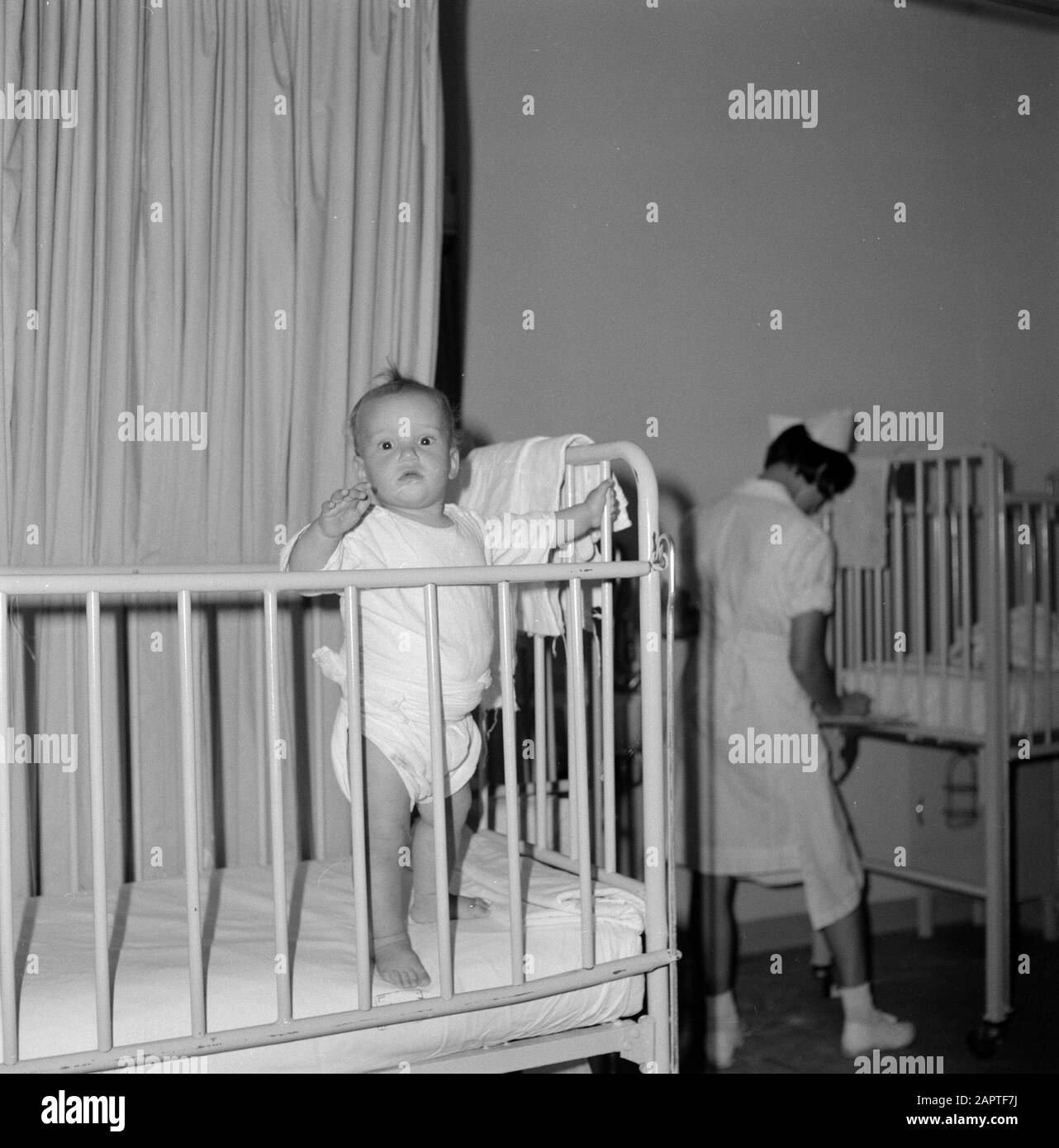 Hadassah university medical center. Department of Pediatrics. A patientje standing in bed Date: 1960 Location: Israel Keywords: beds, children, hospitals Stock Photo