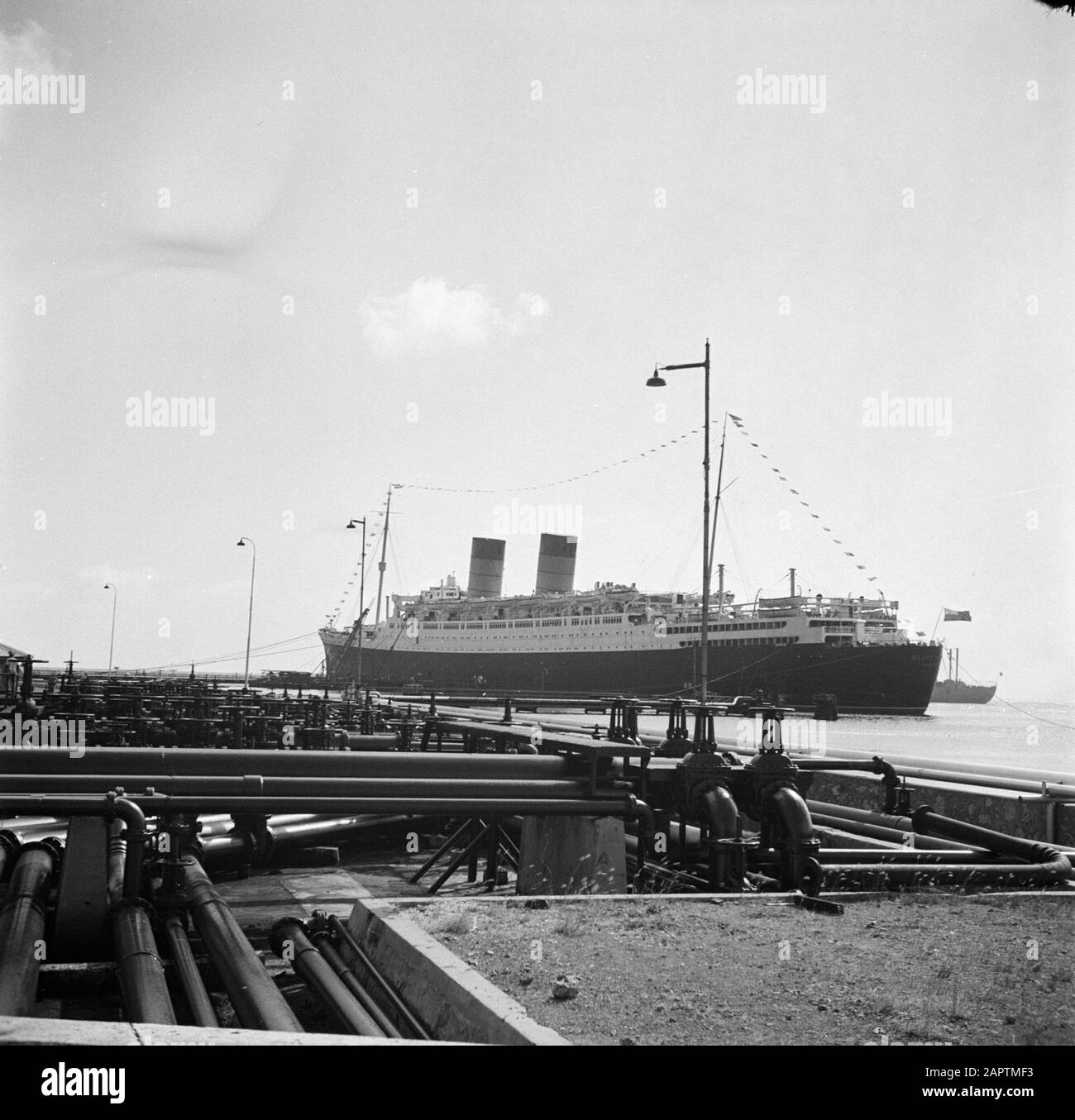 Journey to Suriname and the Netherlands Antilles  The ship de Mauretania in the Caracas Bay on Curaçao Date: 1947 Location: Curaçao Keywords: refineries, ships Stock Photo