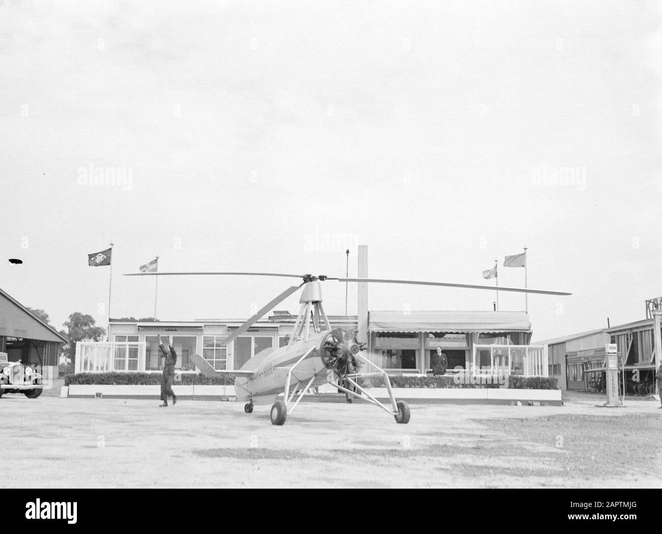 National Aviation School Holland  Starting the Cierva autogiro (Donna Dulcinea) of the Dutch Aviation School at the Rotterdam airport Waalhaven. Left the mecano with raised hands Date: 1935 Location: Rotterdam, Waalhaven Keywords: special aircraft, mechanics, pilots, flight training Personnel: Cierva, Juan de Stock Photo