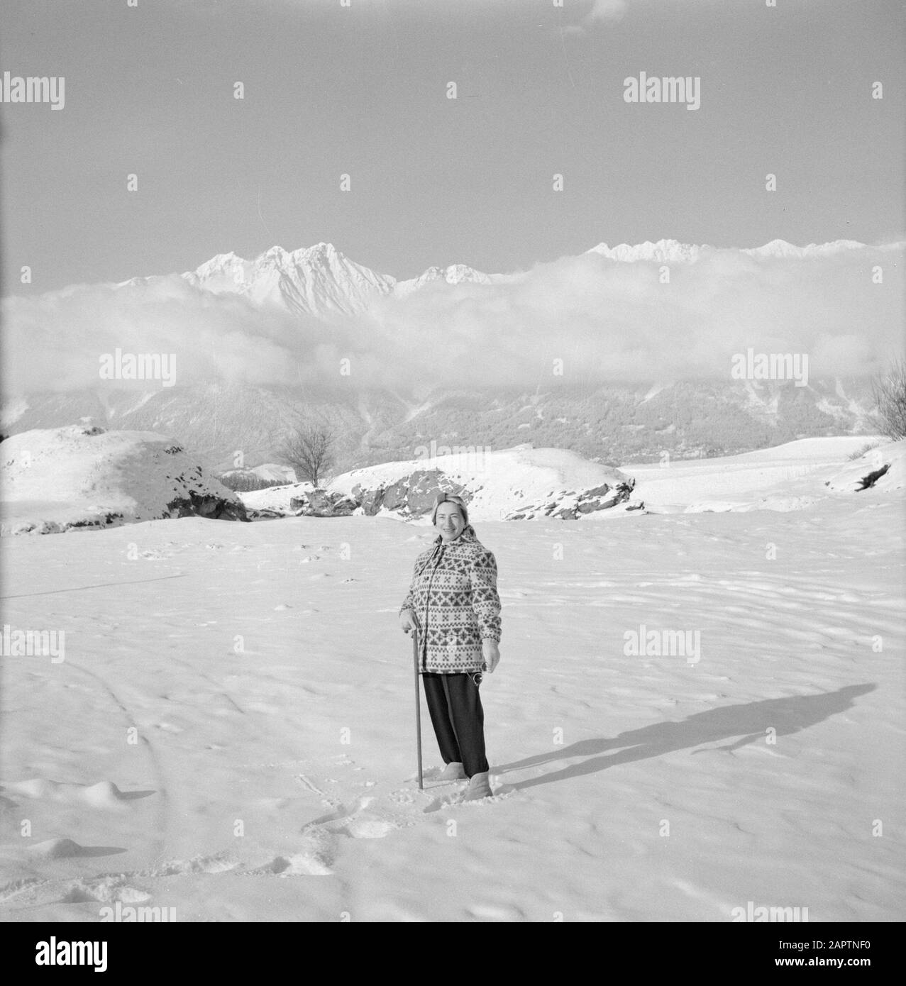 Winter in Tyrol  Hilde Eschen poses in the snow with in the background the Karwendel Mountains Date: January 1960 Location: Austria, Sistrans, Tyrol Keywords: mountains, landscapes, snow, holiday, hiking, winter Personal name: Echen, Hilde Stock Photo