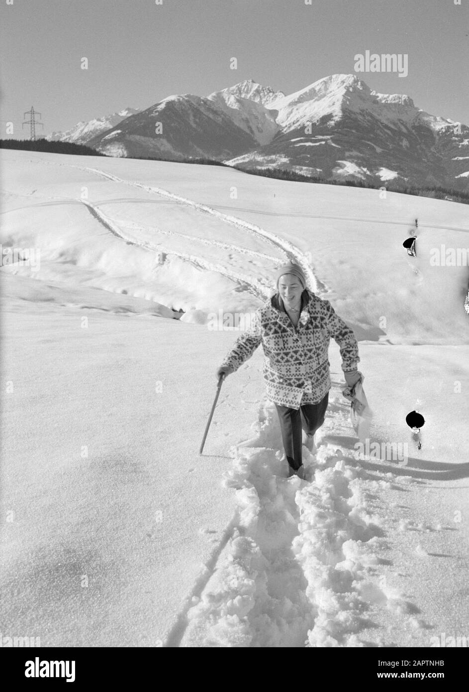Winter in Tyrol  Hilde Eschen walks in the snow with in the background the Karwendel Mountains Date: January 1960 Location: Austria, Sistrans, Tyrol Keywords: mountains, landscapes, snow, holiday, hiking, winter Personal name: Echen, Hilde Stock Photo