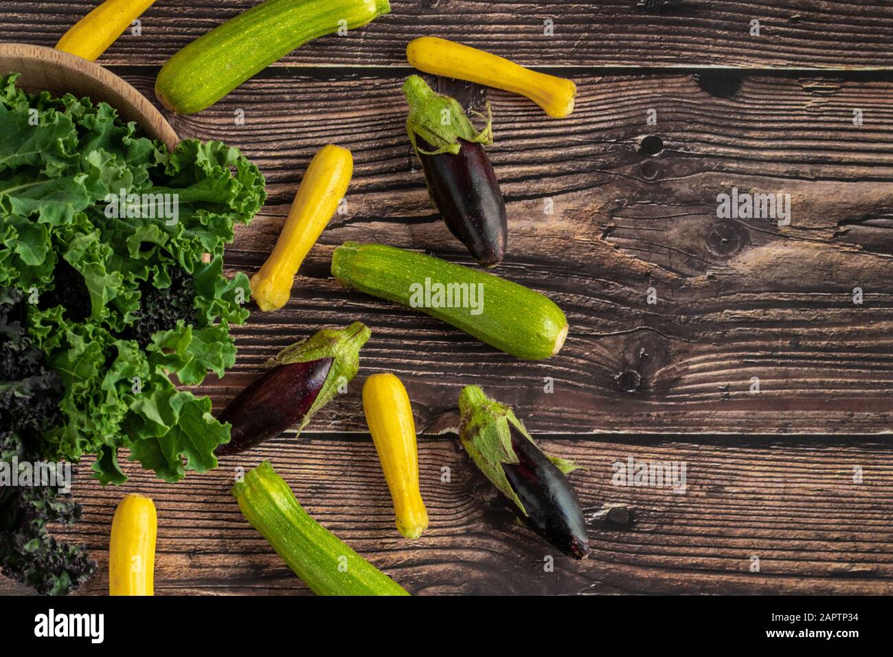 green leafy kale vegetable in bamboo bowl on wooden table background Stock Photo