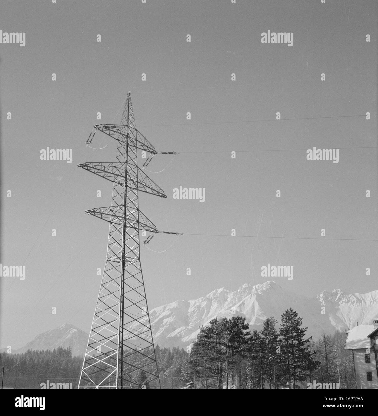 Winter in Tyrol  High voltage mast with the Karwendel Mountains in the background Date: January 1960 Location: Austria, Sistrans, Tyrol Keywords: mountains, electricity, high voltage masts, landscapes, snow, winter Stock Photo