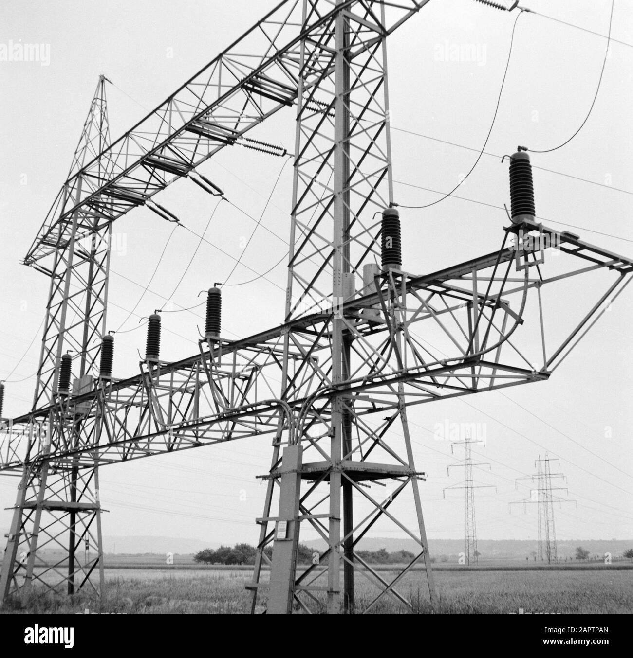 Rhine navigation, report from tug Damco 9: West Germany  High voltage mast with insulators and power lines near Koblenz Date: 1 April 1955 Location: Germany, Koblenz, West Germany Keywords: electricity, high voltage masts, landscapes Stock Photo