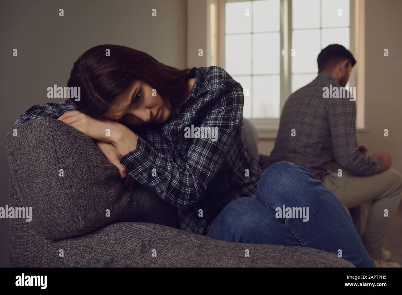 A young couple quarreling while sitting on a sofa in a room Stock Photo ...