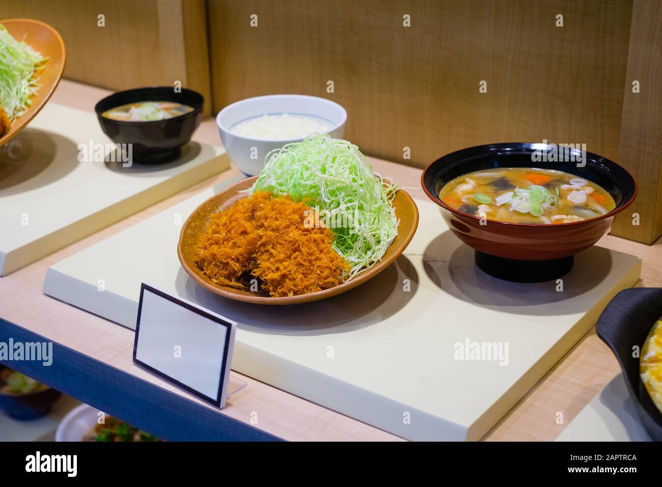 fake, plastic food menu in asian restaurant window - Stock Photo