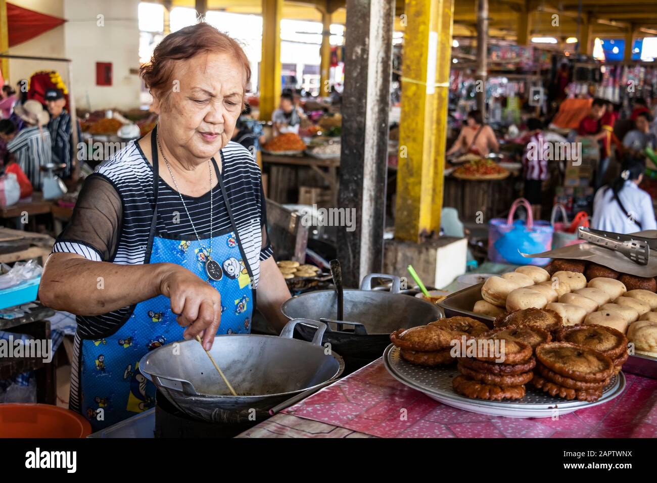 Woman preparing sweets at the Tomohon Market; Tomohon, North Sulawesi, Indonesia Stock Photo