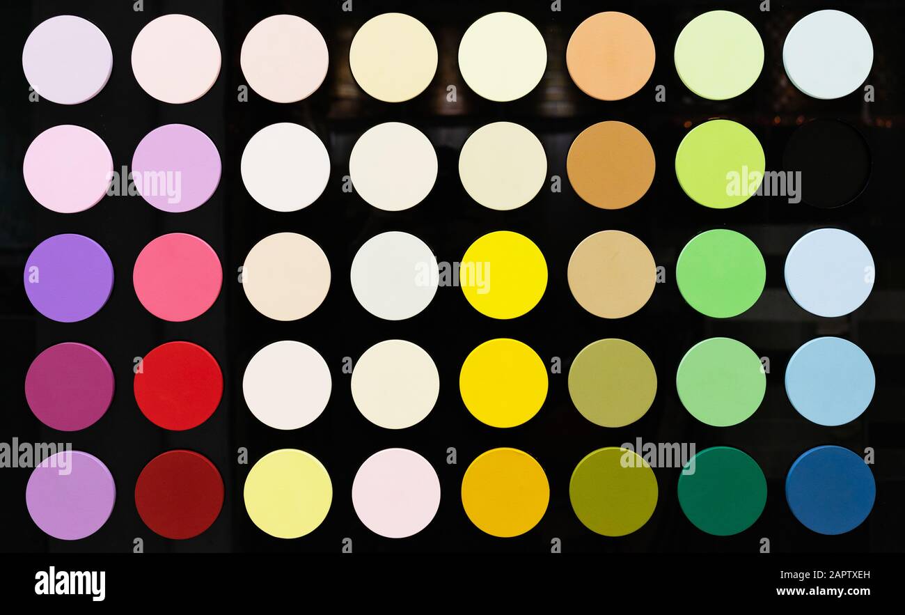 Circles with a color palette on a black glossy background. ?olor palette  from saturated colors to neutral Stock Photo - Alamy