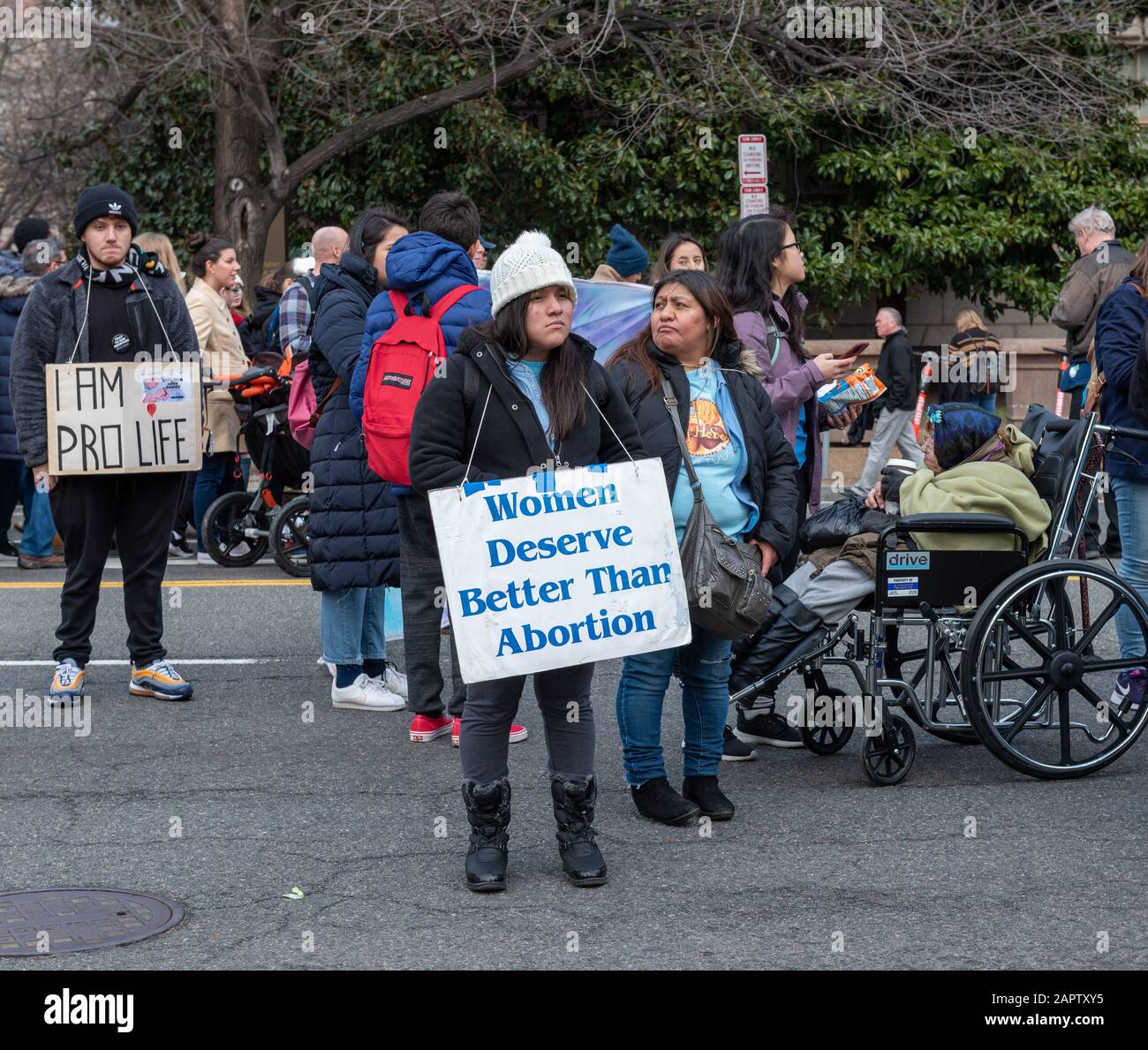 Washington DC, USA — March 24, 2020. A woman stands in the street holding a sign protesting abortion at the annual March for life rally in Washington, Stock Photo