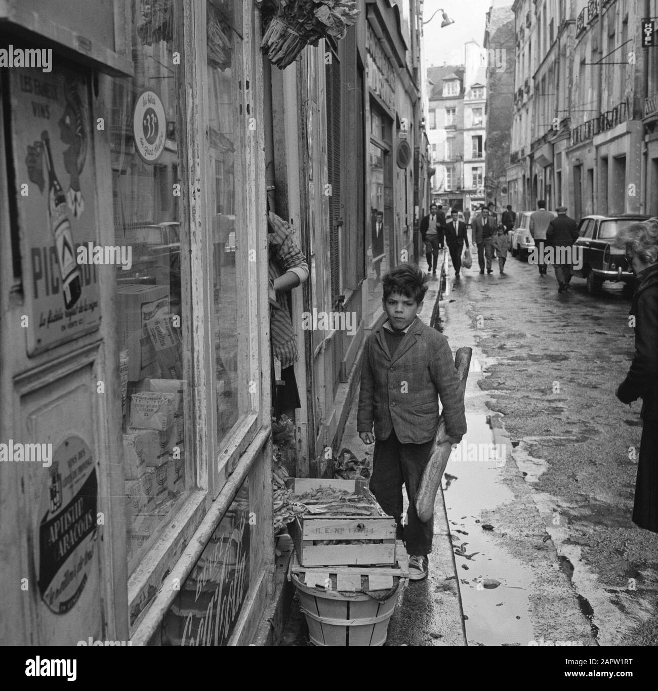 Pariser Bilder [The street life of Paris]  Boy with baguette Date: 1965 Location: France, Paris Keywords: groceries, bread, children, street images Stock Photo