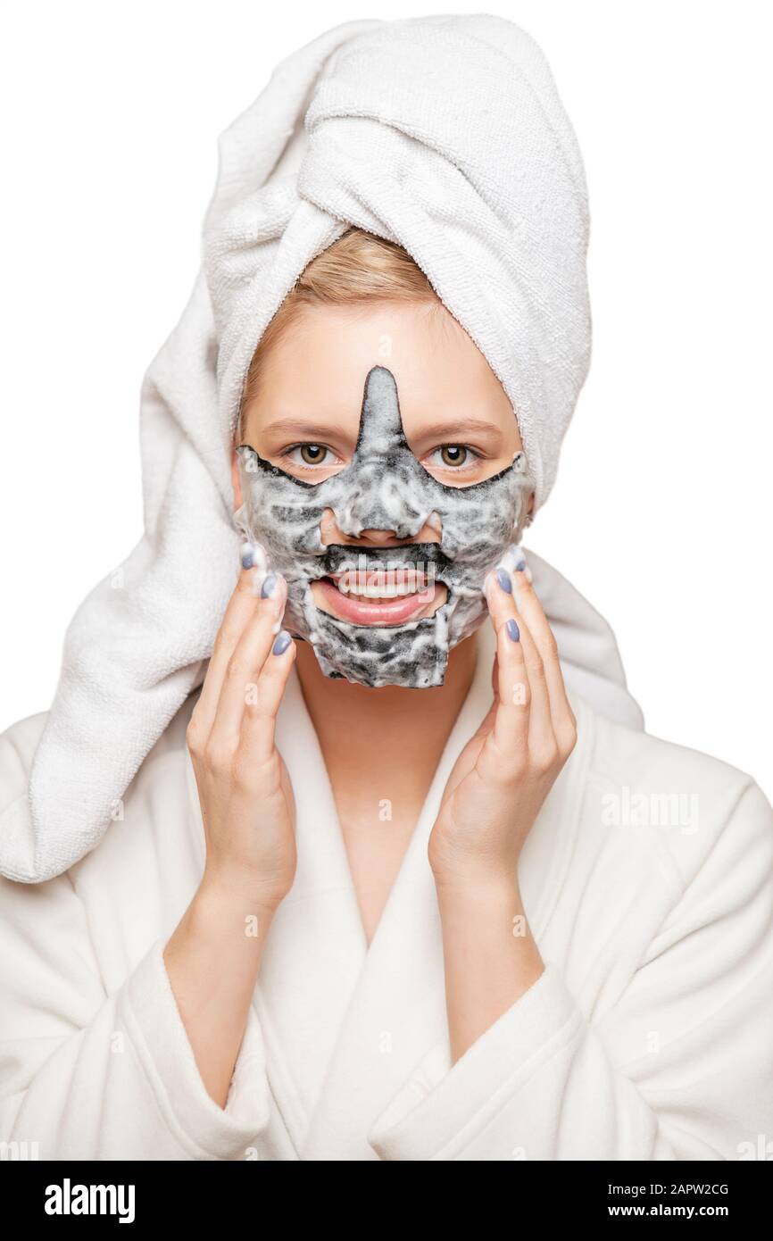Young woman with fresh healthy skin and hairs aplying alginate mask and