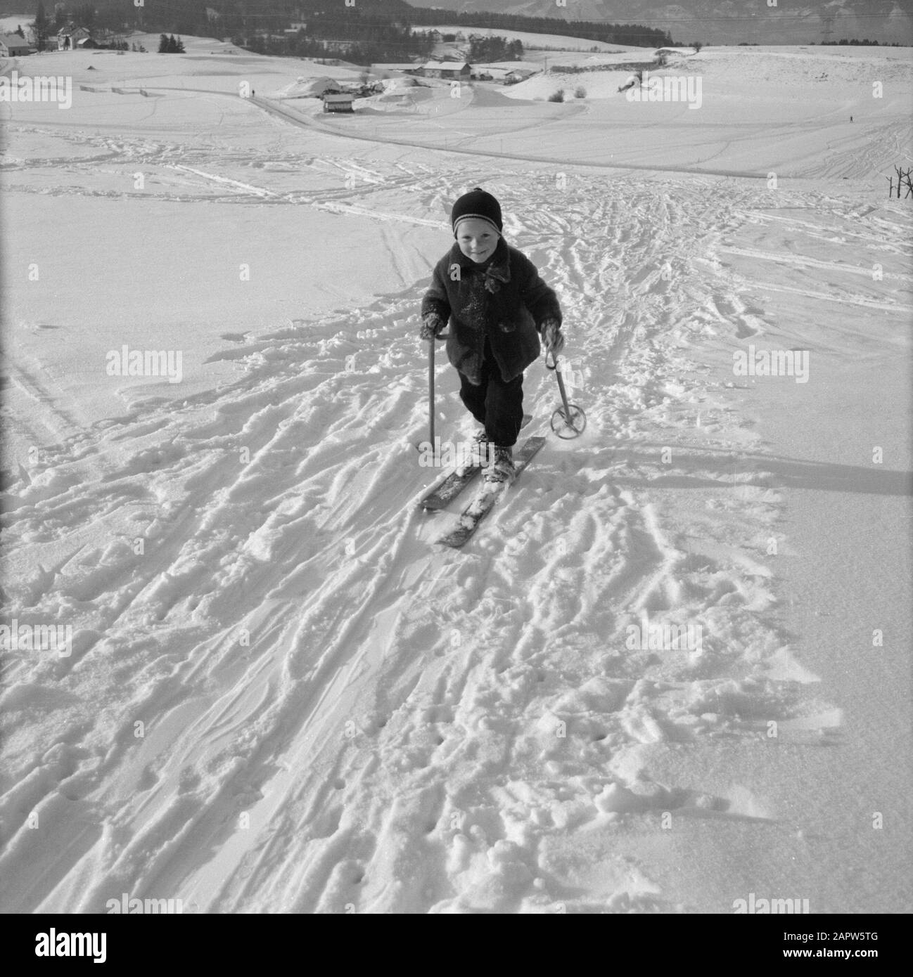 Winter in Tyrol  Child with skis in the snow Date: January 1960 Location: Austria, Sistrans, Tyrol Keywords: mountains, landscapes, cross-country skiing, skiing, snow, winter, winter sports Stock Photo