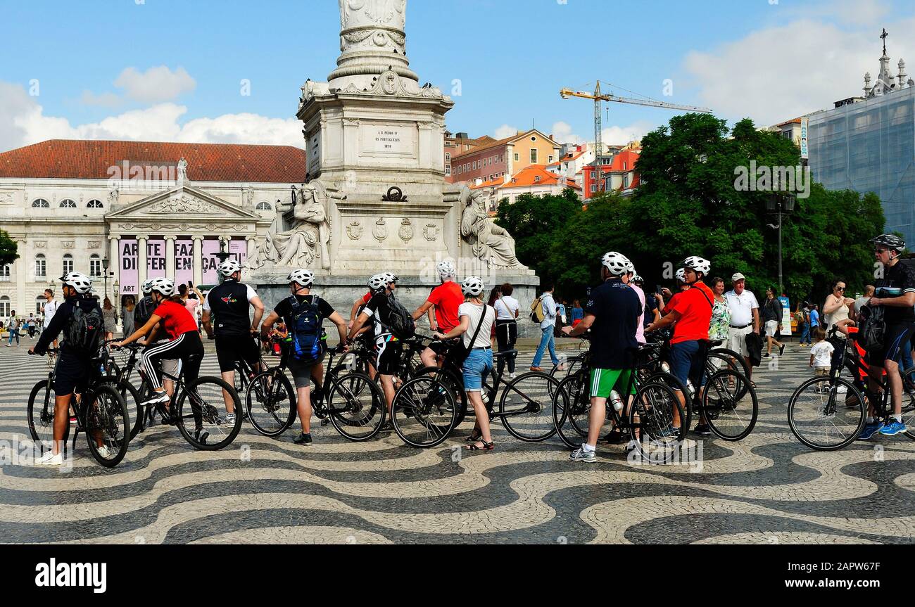 A group of tourist cyclists taking a break in the Rossio, Lisbon, Portugal Stock Photo