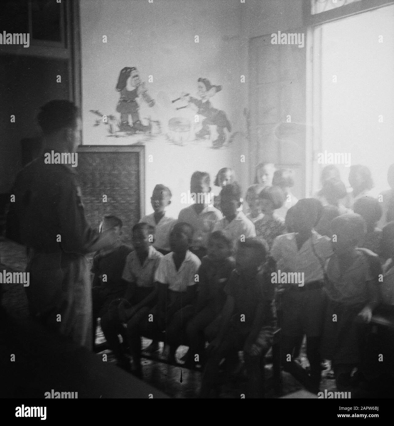 Kindertehuis West-Java in Buitenzorg  Children's Choir with a military conductor Date: April 8, 1948 Location: Indonesia, Dutch East Indies Stock Photo