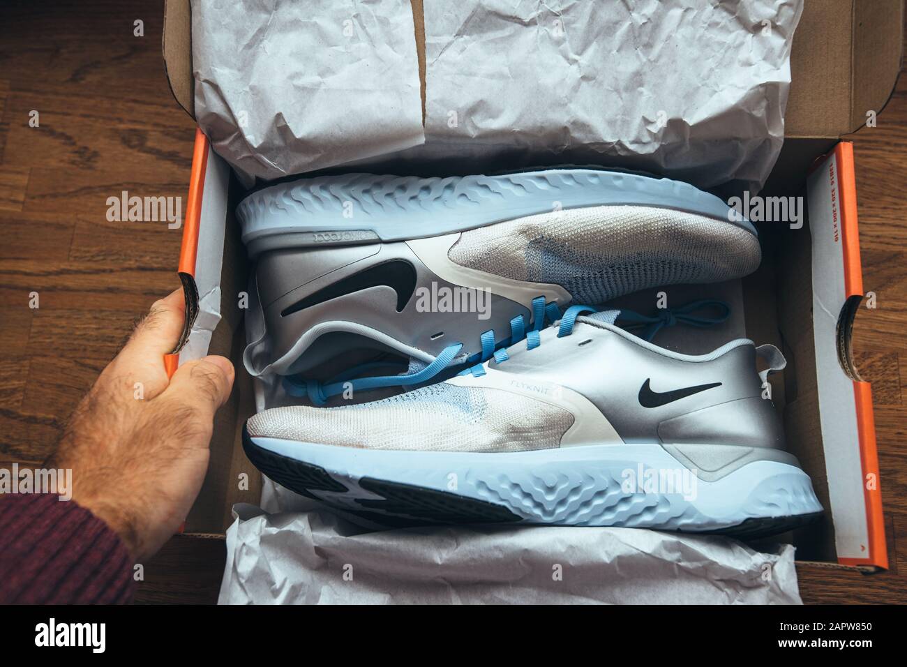 Paris, France - Sep 23, 2019: Personal perspective Unboxing unpacking on  wooden table pair of new Nike female running professional shoes Nike  Odyssey Reakt 2 Flyknit PRM Stock Photo - Alamy