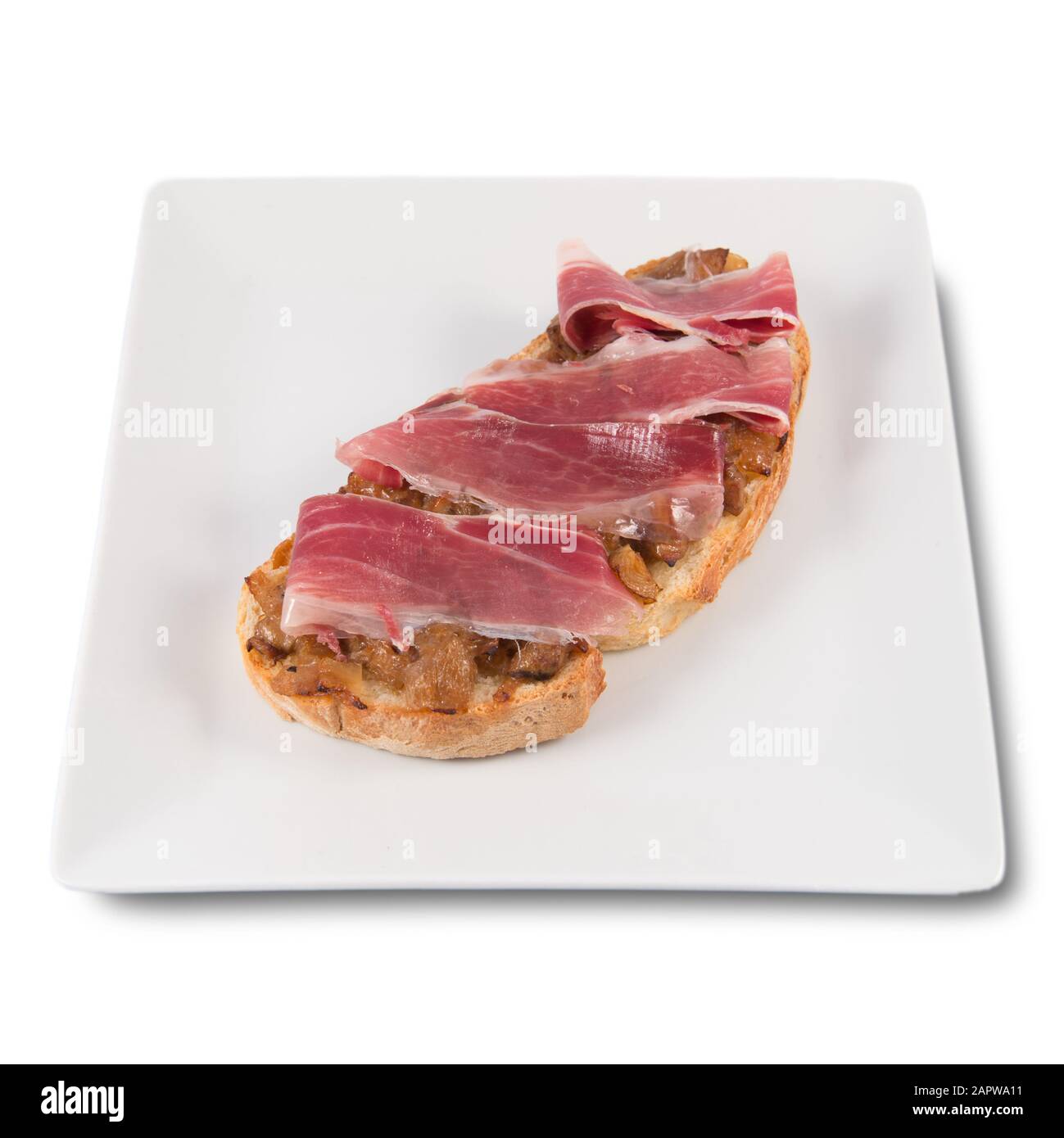 A toast of boletus and iberian ham Stock Photo - Alamy