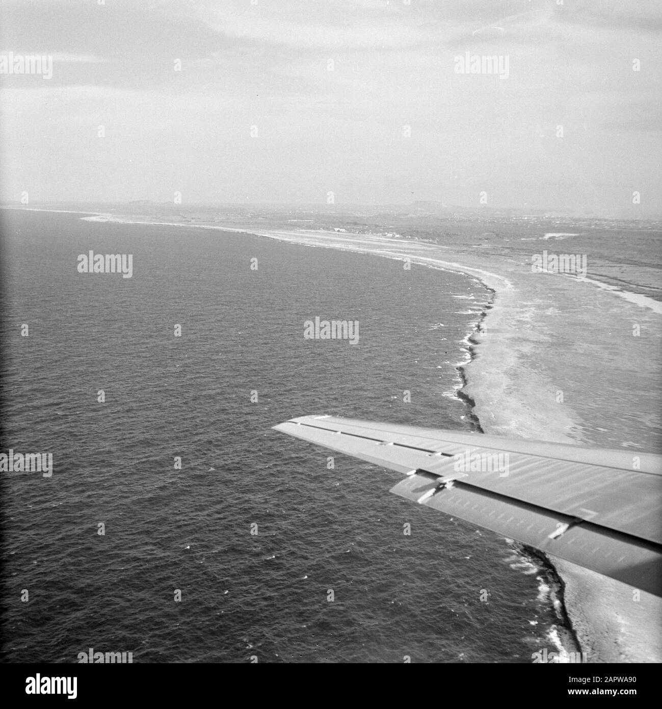 Dutch Antilles and Suriname at the time of the royal visit of Queen Juliana and Prince Bernhard in 1955  Coastal Landscape, probably Curaçao, seen from an airplane Date: 1 October 1955 Location: Netherlands Antilles, Suriname Keywords: coast, aerial photographs Stock Photo