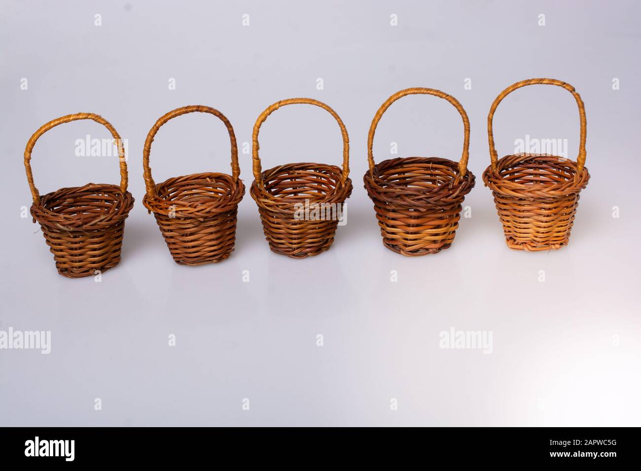 Little size Empty wicker baskets on white background Stock Photo - Alamy