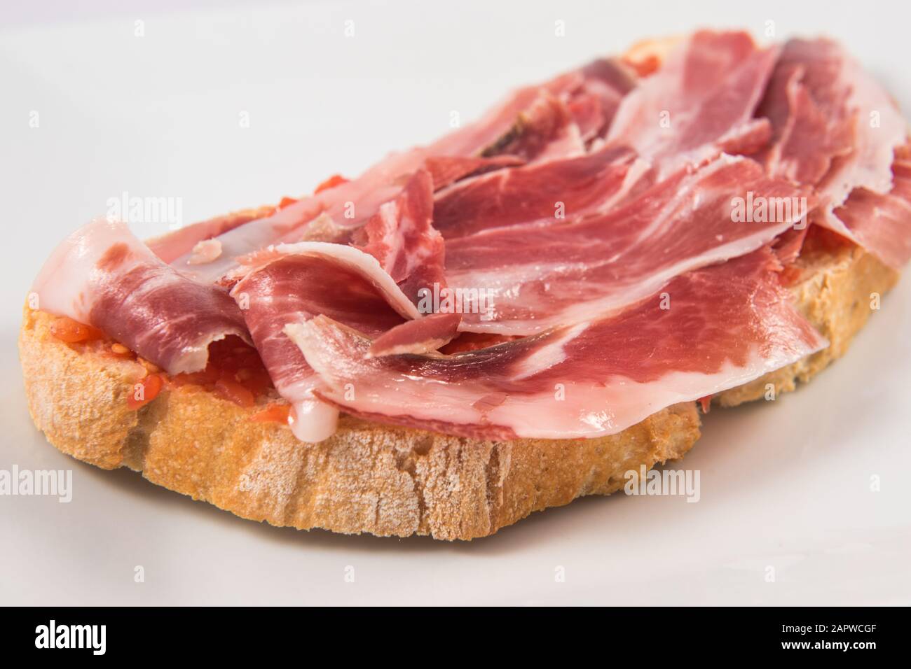 Extremaduran tomato and Iberian ham toast Stock Photo - Alamy