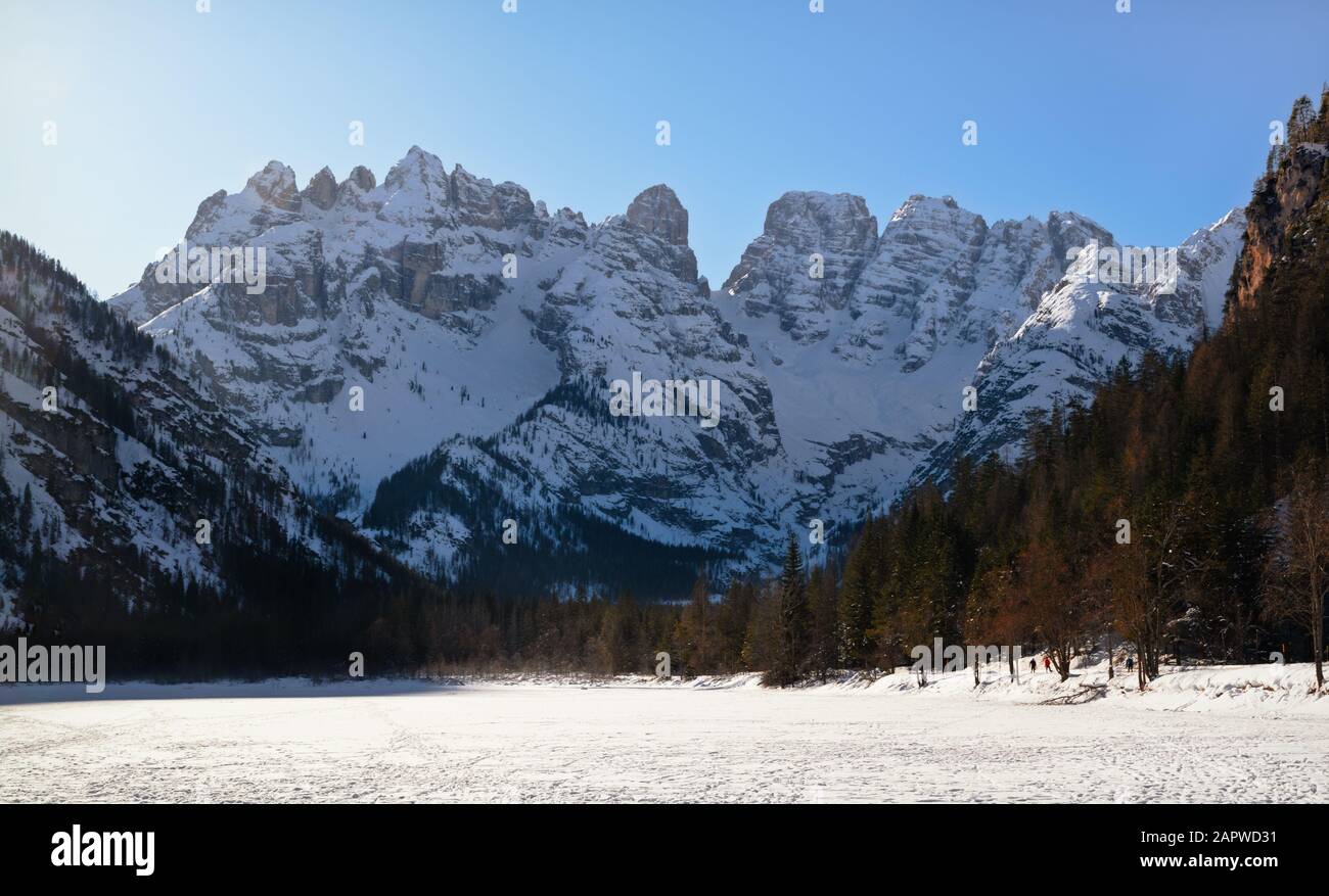 The Landro Lake in the italian dolomites totally ice covered with the snowcapped Monte Cristallo on the background in a winter morning Stock Photo