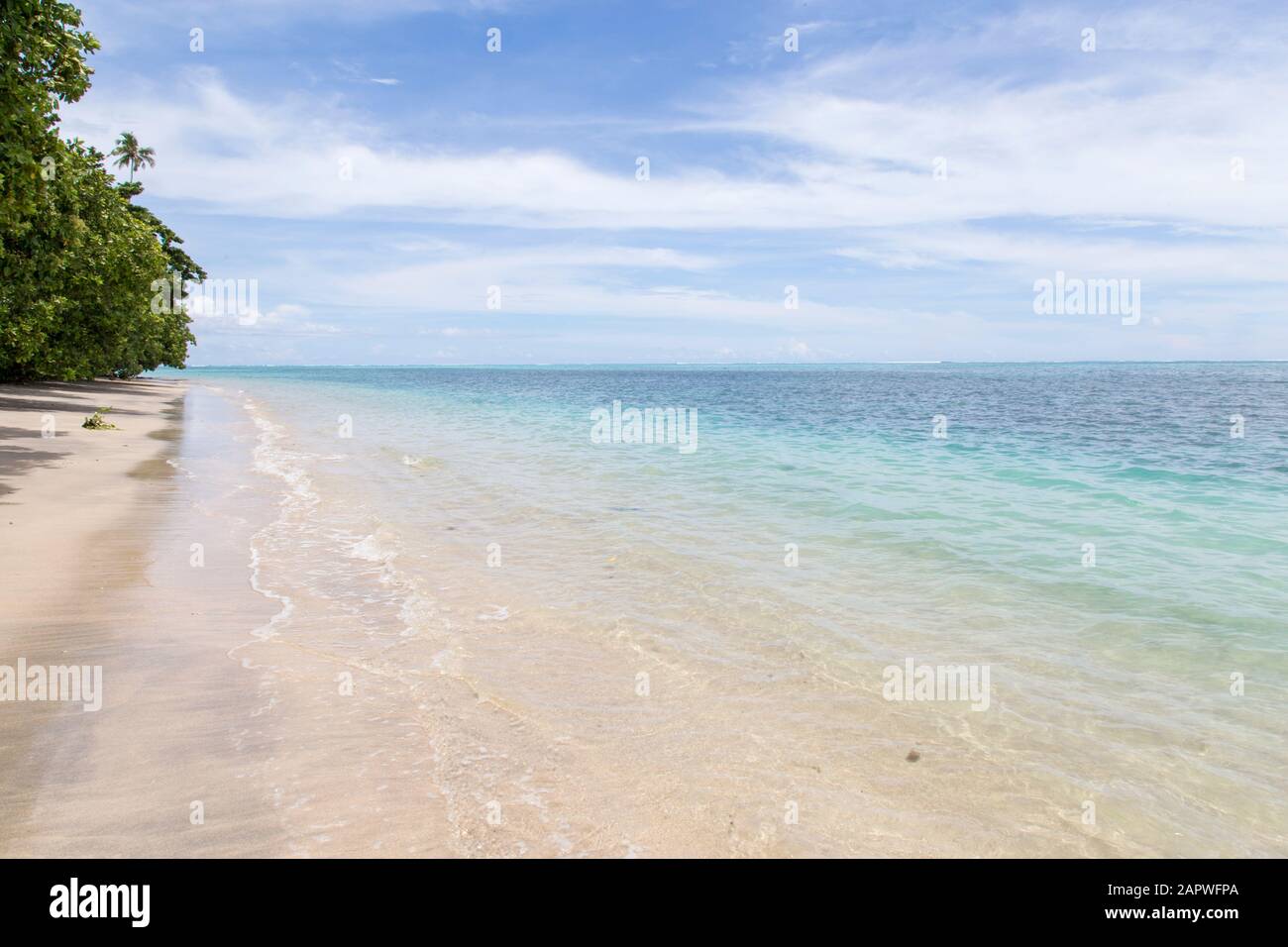 Empty pink sandy beach with clear blue waters in South Pacific island Stock Photo