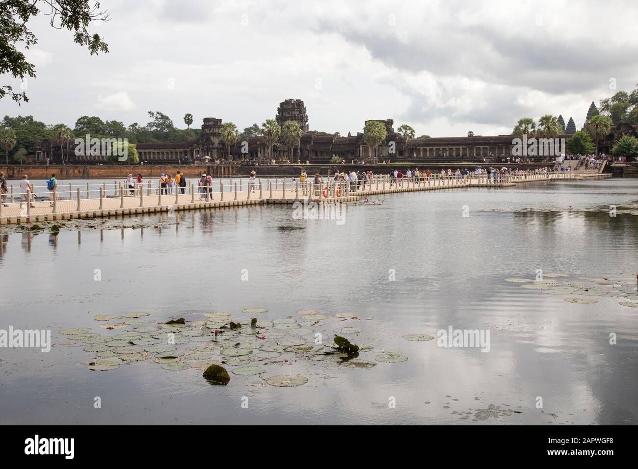 Visitors at main entrance of Angkor Wat during a cloudy morning Stock Photo