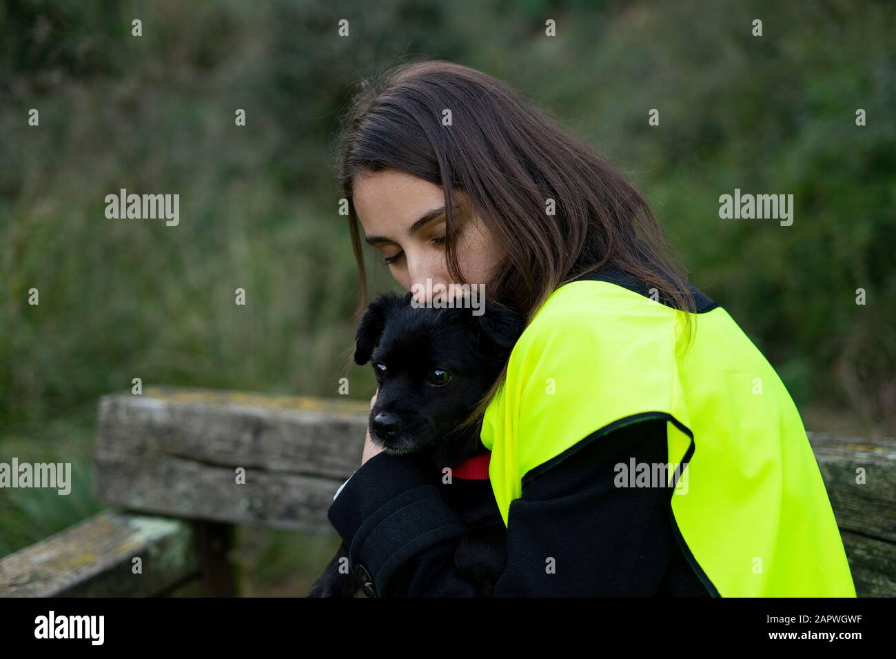Kennel volunteer hugging an abandoned dog. Concept of volunteer and animal abuse. Stock Photo