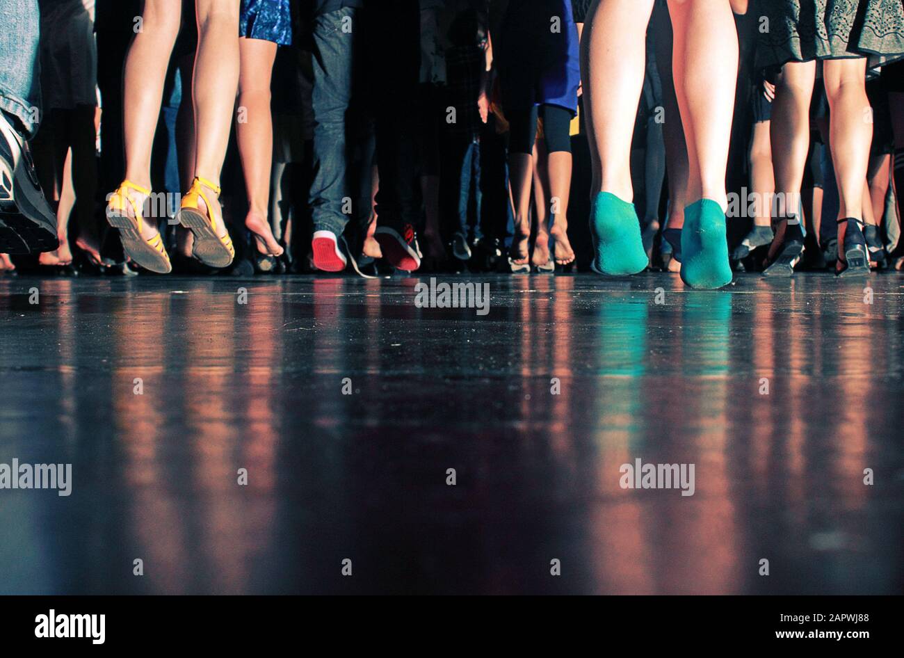 Low angle shot of children jumping on the black floor Stock Photo