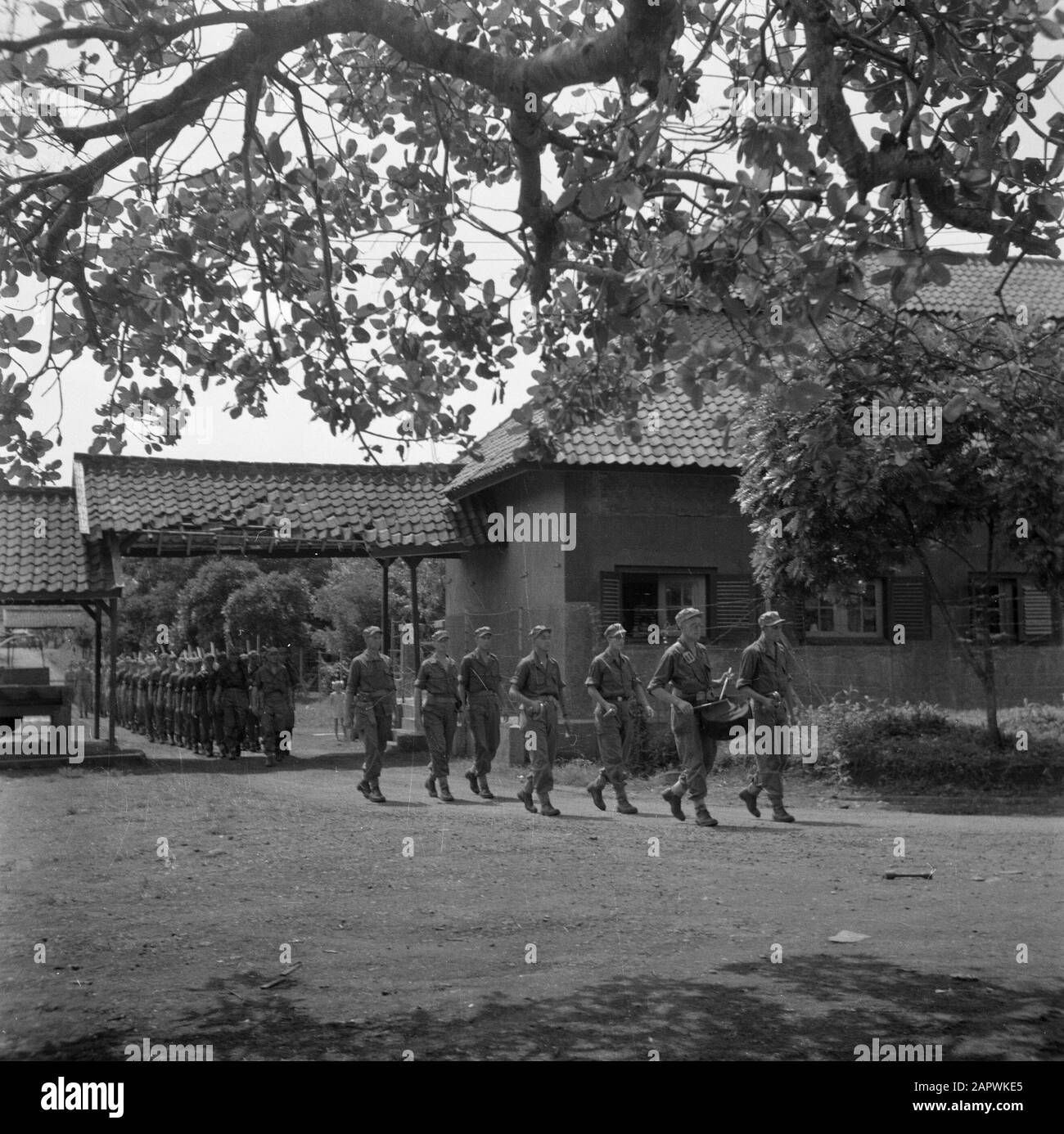 War volunteers in Malacca and Indonesia  Military funeral, column preceded by a tambour with velvet drum Date: March 1946 Location: Indonesia, Indonesia, Java, Dutch East Indies Keywords: funerals, soldiers, drums, funerals Stock Photo