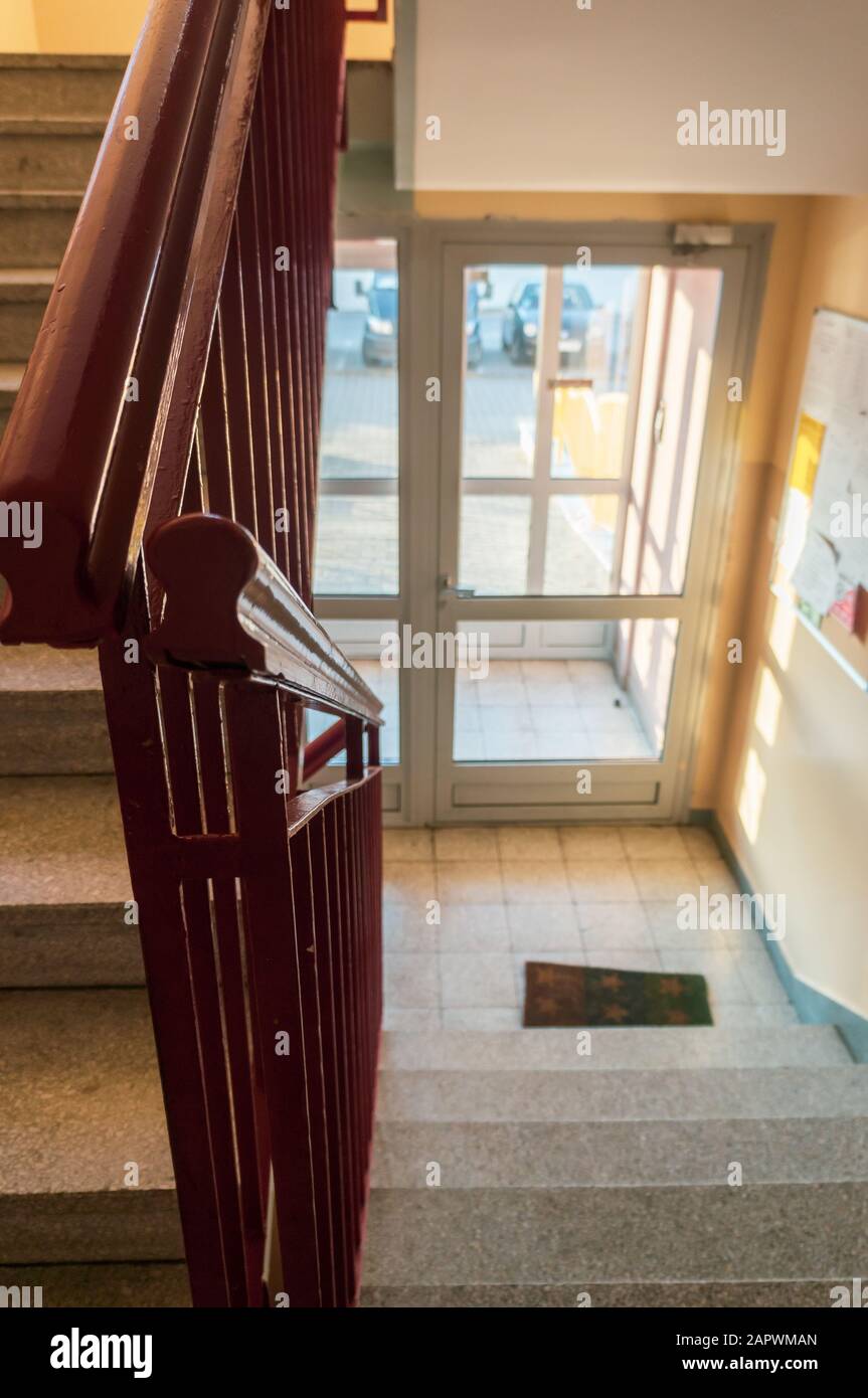 Vertical closeup shot of the wooden railing of a staircase inside a ...