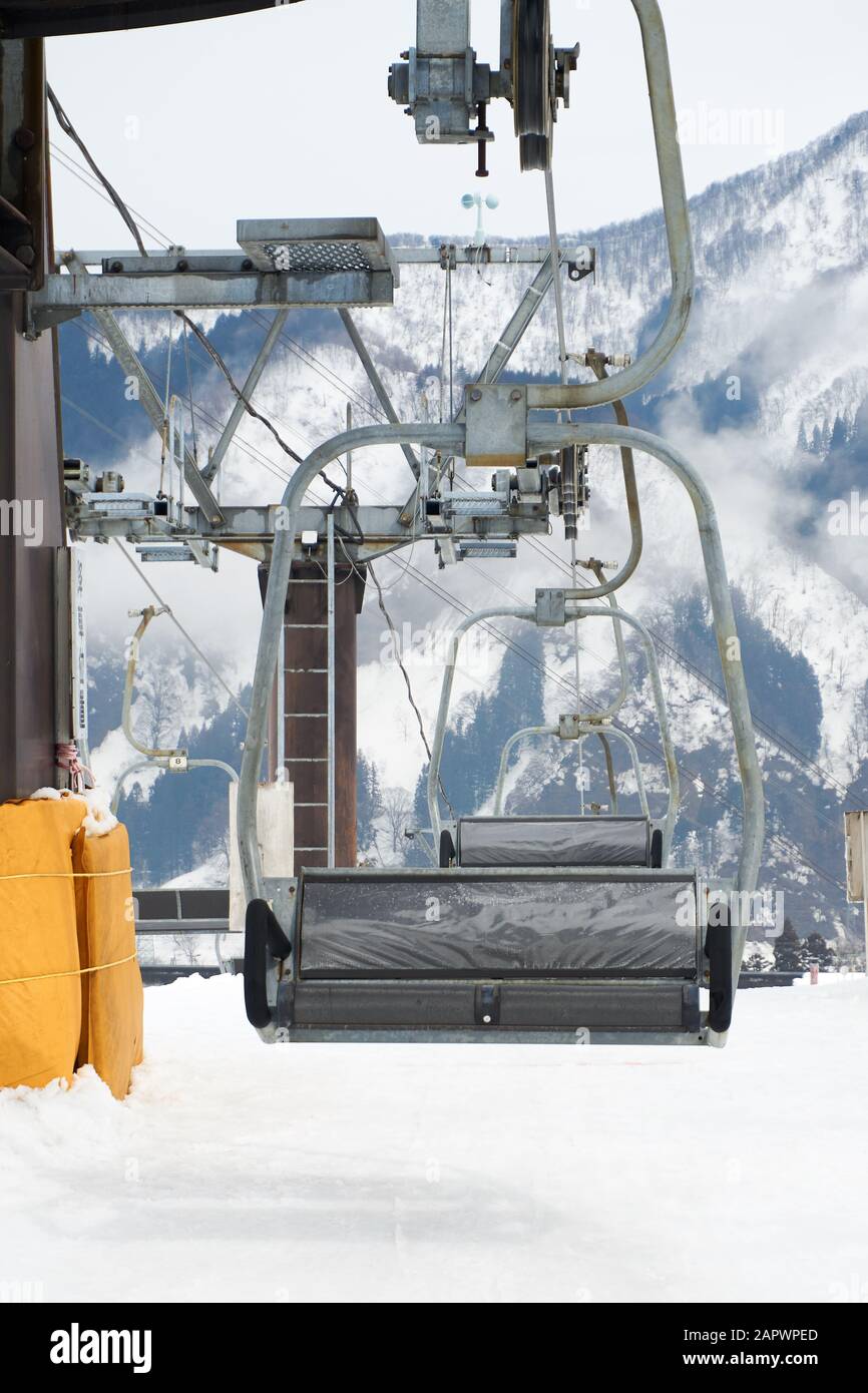 An Empty Ski Chair Lift Ascends A Mountain At A Yuzawa Kogen Ski