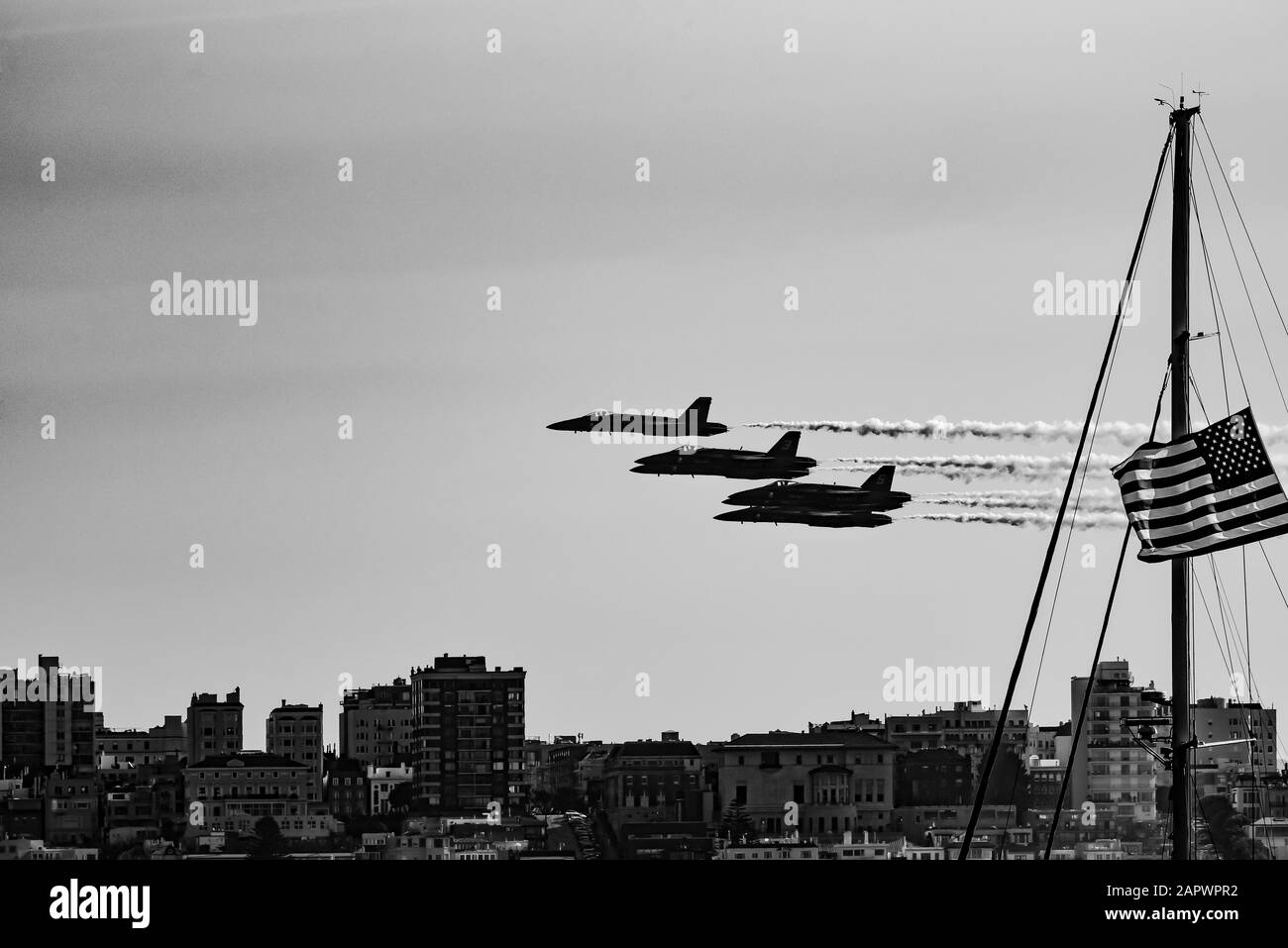 Grayscale shot of fighter jets in the sky with the American flag on the side Stock Photo