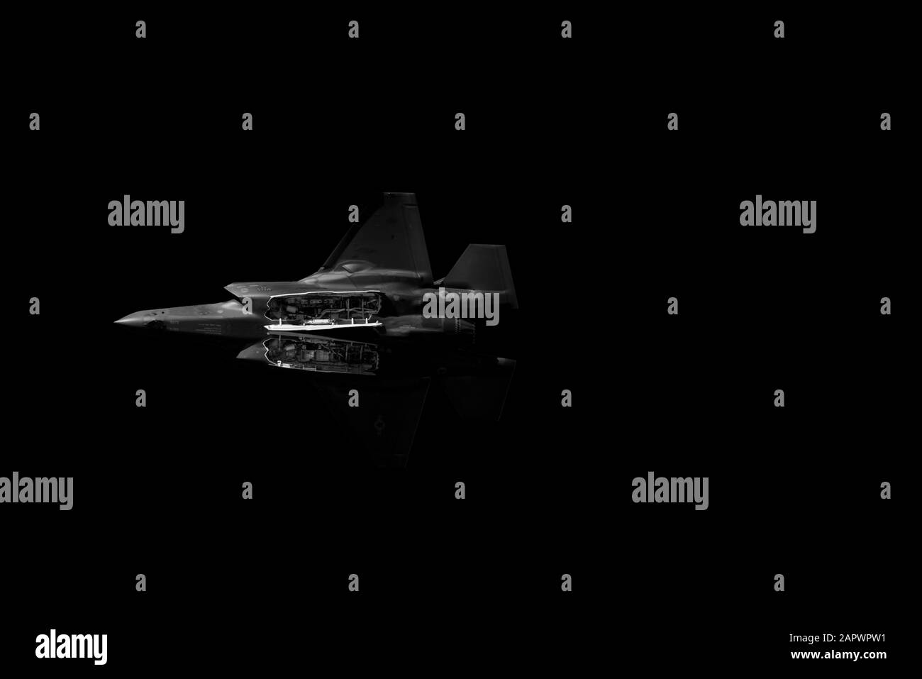 Low angle shot of a single fighter jet plane on dark background Stock Photo