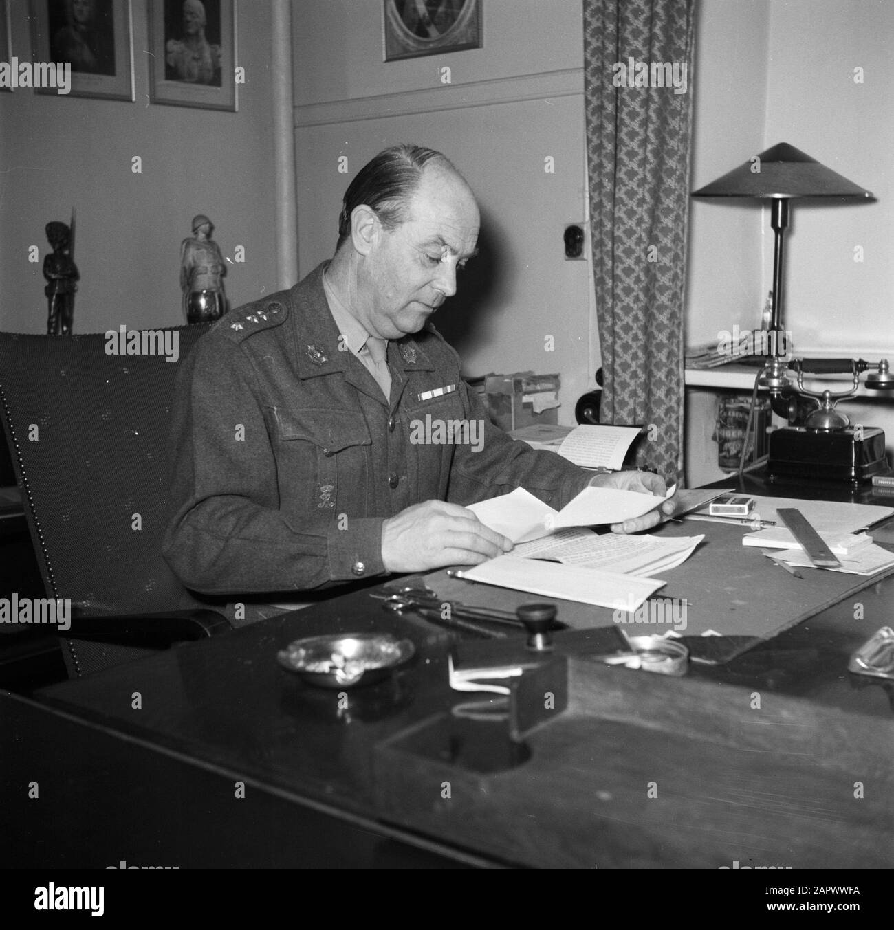Barracks Officer, presumably the commander, behind his desk