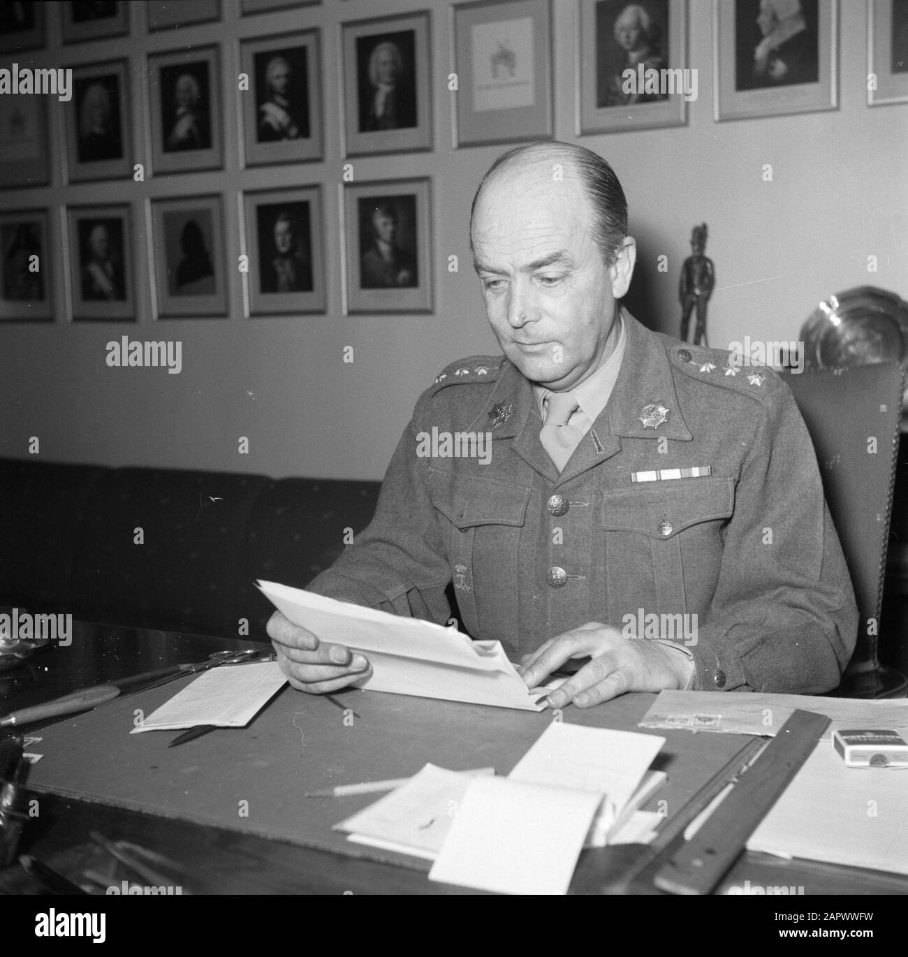 Barracks Officer, presumably the commander, behind his desk
