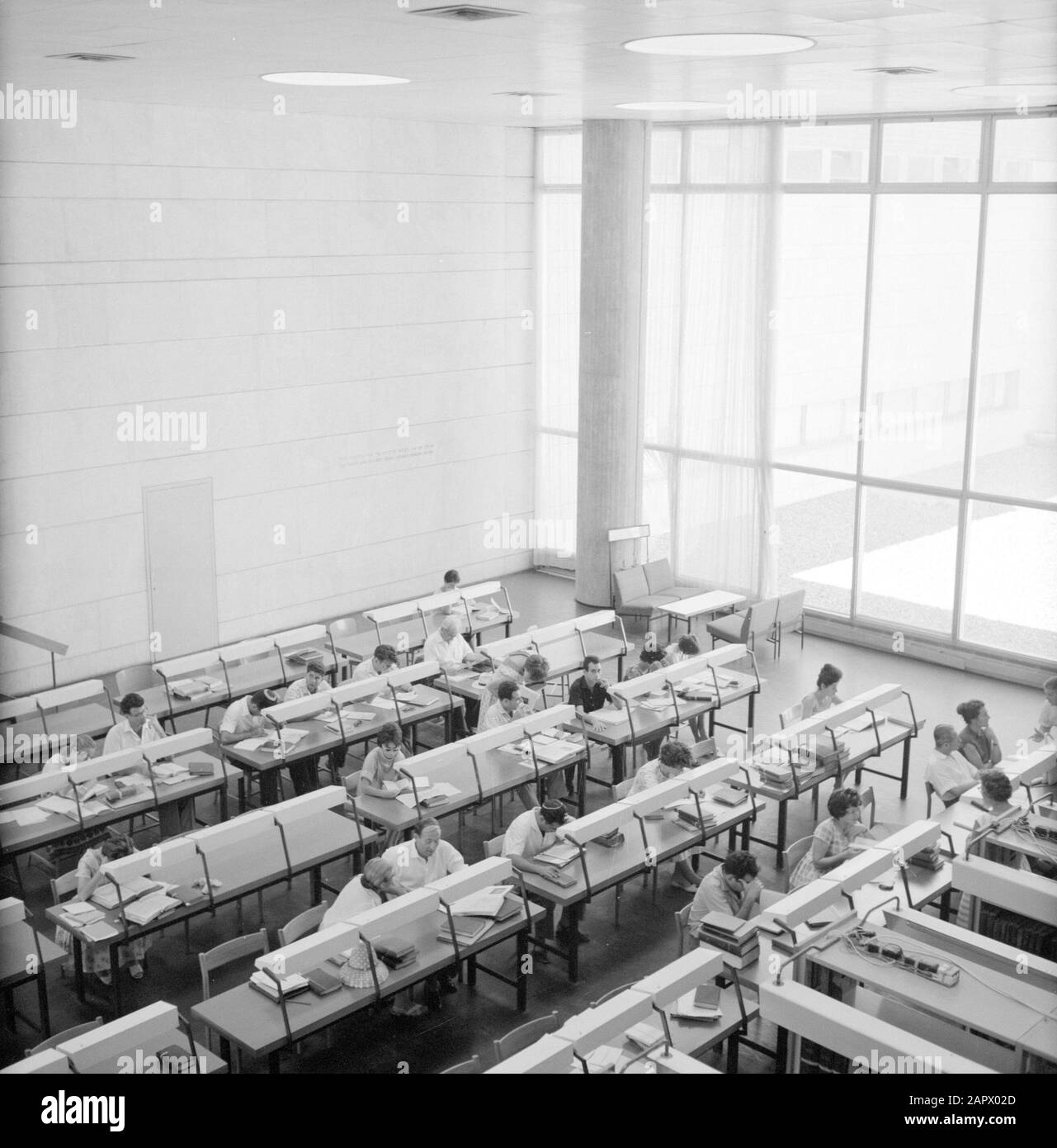 Israel 1964-1965: Jerusalem (Jerusalem), Hebrew University  Overview photo taken from above with students at reading tables in a university building, presumably the library Annotation: On April 1st 1925, the Hebrew University of Jerusalem was opened during a festive ceremony attended by the leaders of the world. The first board of the University consisted of such celebrities as Albert Einstein, Sigmund Freud, Martin Buber, James Rothschild and Sir Alfred Mond Date: 1964 Location: Israel, Jerusalem Keywords: libraries, buildings, reading tables, students, universities Stock Photo