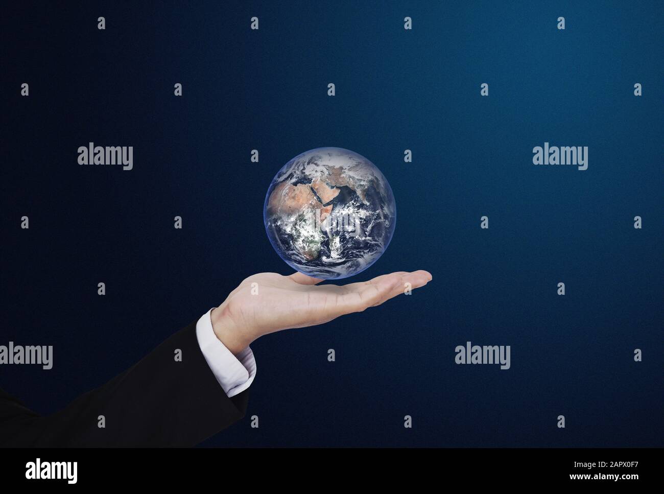 Businessman holding globe, on blue background. Global business concept. Element of this image are furnished by NASA Stock Photo